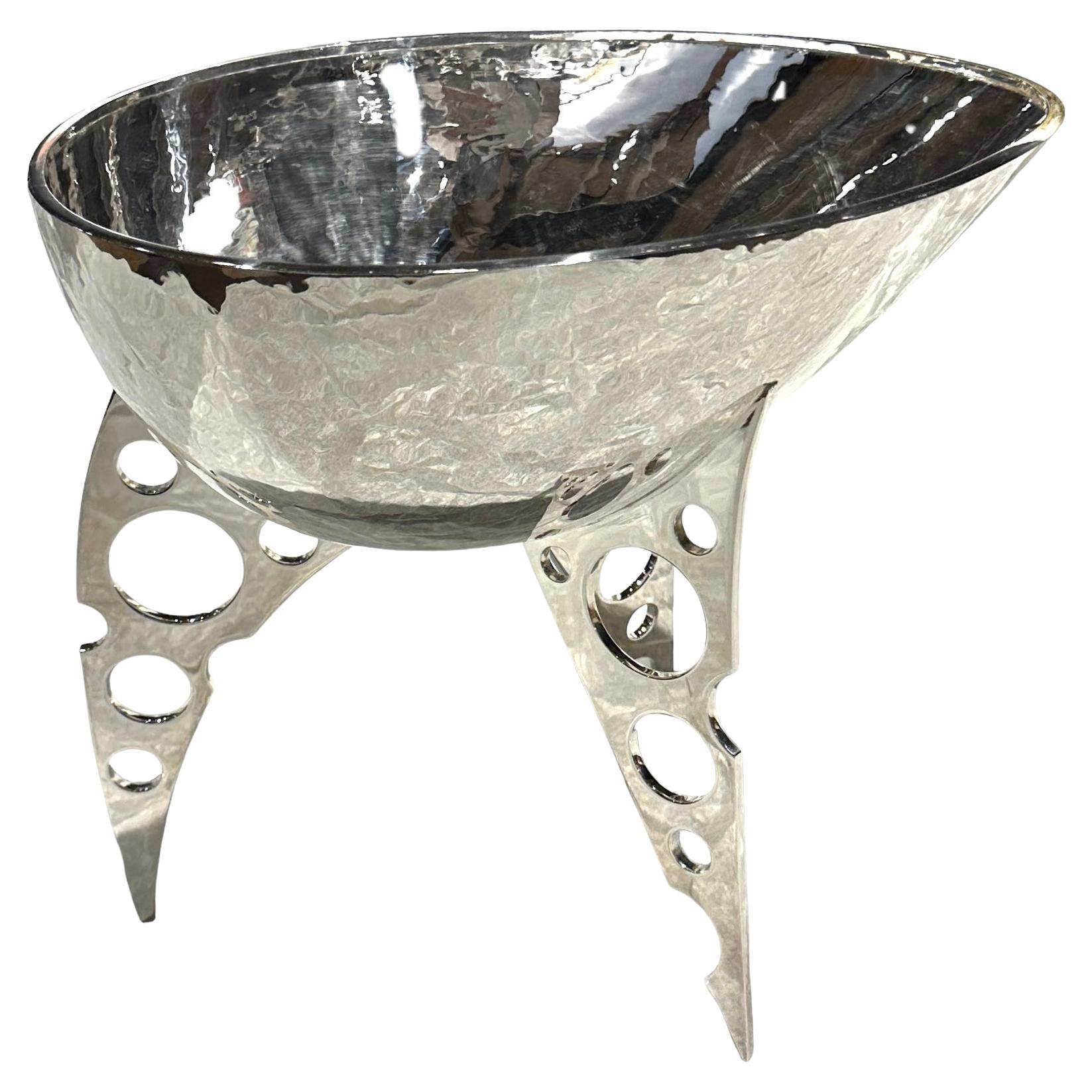 Organic and industrial shapes fuse in this inverted and fierce warrior helmet of the Norse warlord.  Playfully malevolent tension -arrests the bowl atop the dagger like legs.  This minimalist design and natural form made of  silver is both beautiful