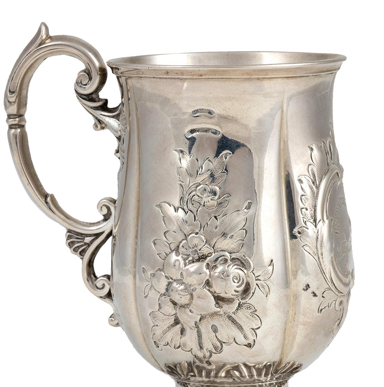 You are admiring a magnificent silver Victorian mug, realized in the Victorian London during the years 1857-1858.

Made of 925/1000 silver. Weight 0.158 Kgs.

This mug is embossed and chiseled with floral decorations.
Its realization is by John