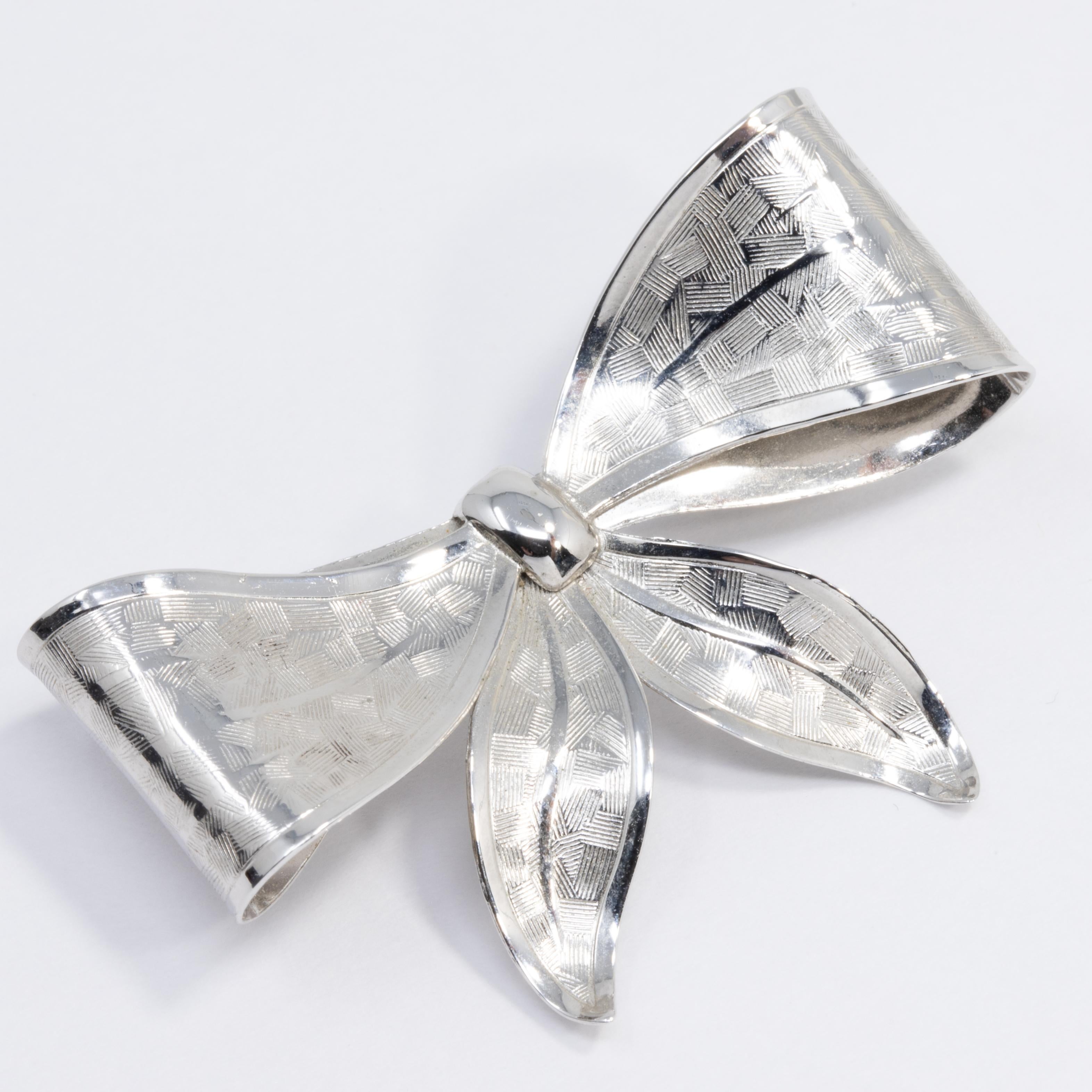 An elegant sterling silver vintage bow pin.

Hallmarks: Co Sterling