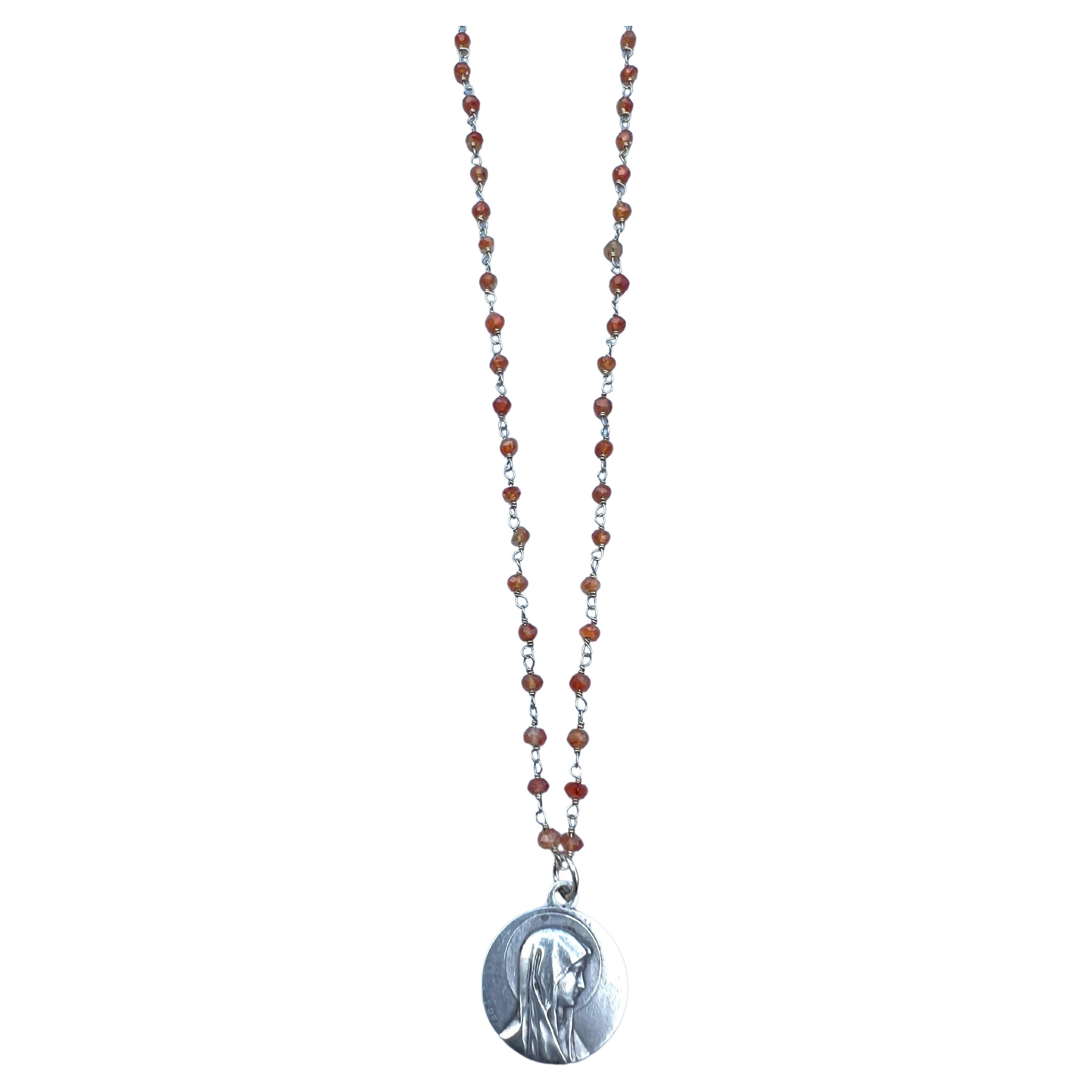 Silver Virgin Mary Medal Necklace Carnelian Rosario

This Silver Vintage Virgin Mary Medal with a Carnelian Rosario Chain Necklace combines spiritual symbolism with classic design. The centerpiece of this necklace is the Silver Virgin Mary Medal,