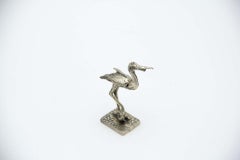 Silver wading bird on a rectangular base
