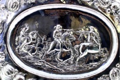 Silver wall salver with battle scene, monogram & ornate relief