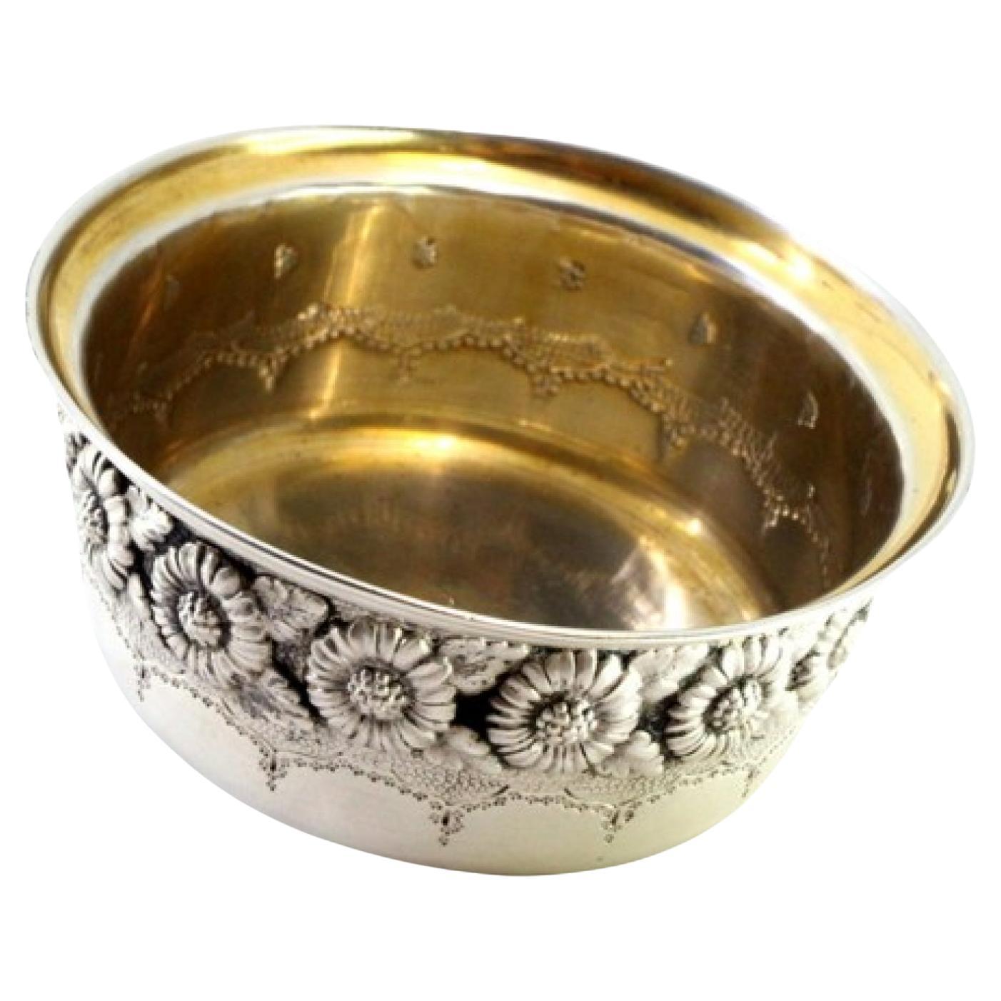 Silver washbasin with revealed floral engravings and gold interior