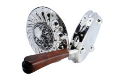 Silver whisk with reliefs, knight's helmet, coat of arms and wooden handle