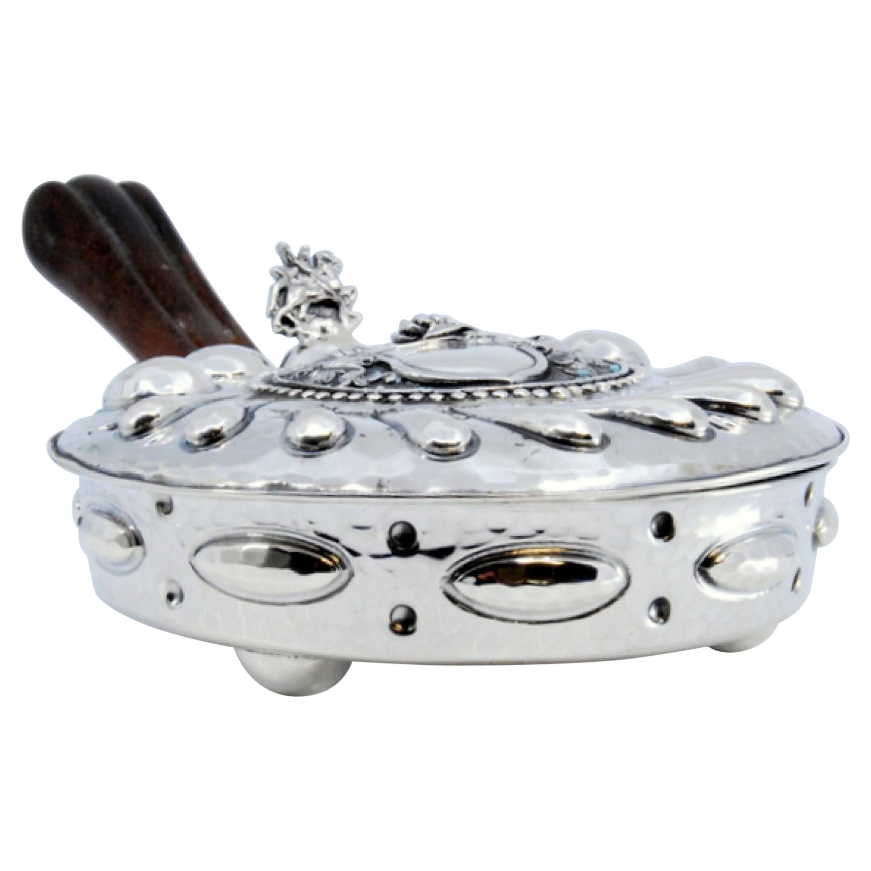 Silver whisk with reliefs, knight
s helmet, coat of arms and wooden handle