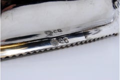 Silver whisk with wooden handle, edge trim and knob on the lid