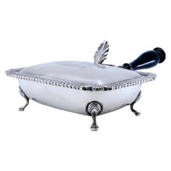 Silver whisk with wooden handle, edge trim and knob on the lid