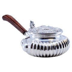 Silver whisk with wooden handle, embossed lid and fluted tank