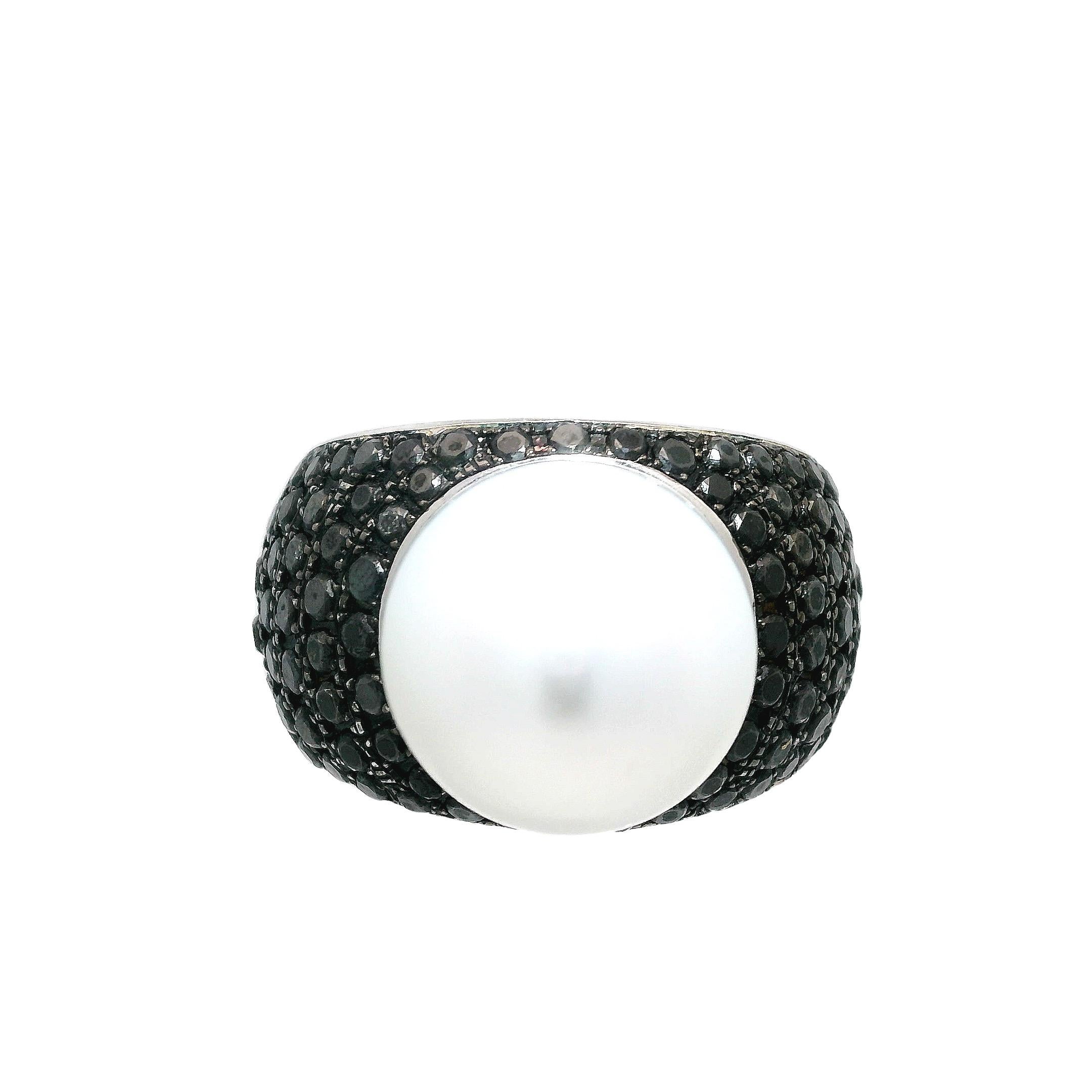 This captivating ring exudes unparalleled opulence and sophistication. Crafted with the utmost attention to detail in 18-karat white gold, it showcases a breathtaking 14.72mm Silver White South Sea pearl as its centerpiece. Surrounding this