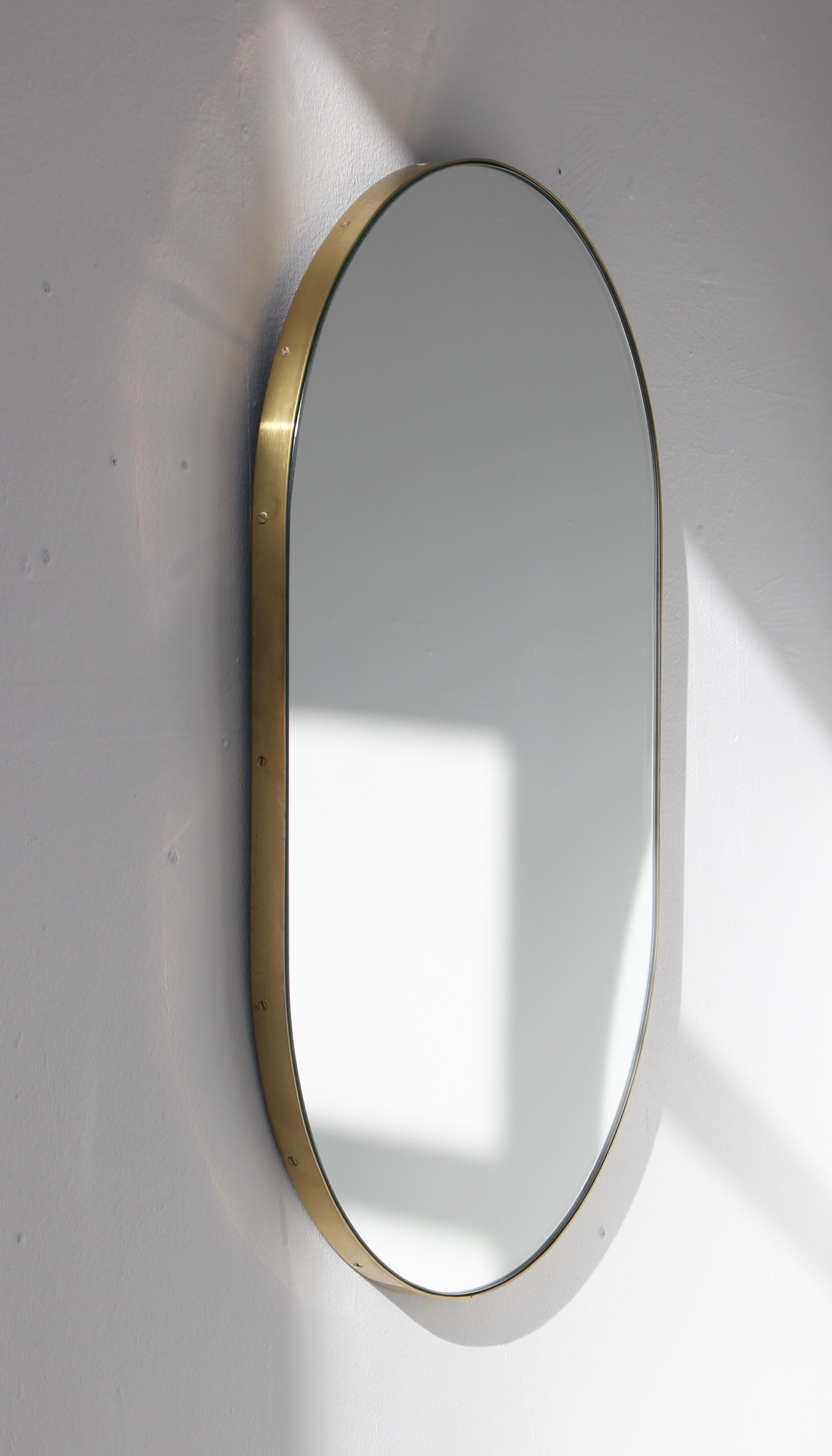 Delightful handcrafted silver capsule shaped mirror with a brass frame.

Ideal above a console table in the hallway, above a beautiful fireplace, in the bedroom or in the bathroom.

Available with a bronze or black tint.

Measures: W 370 x H