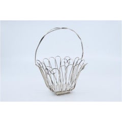 Silver wire basket with hinged handle and resting on a square base