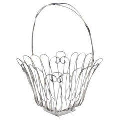 Silver wire basket with hinged handle and resting on a square base