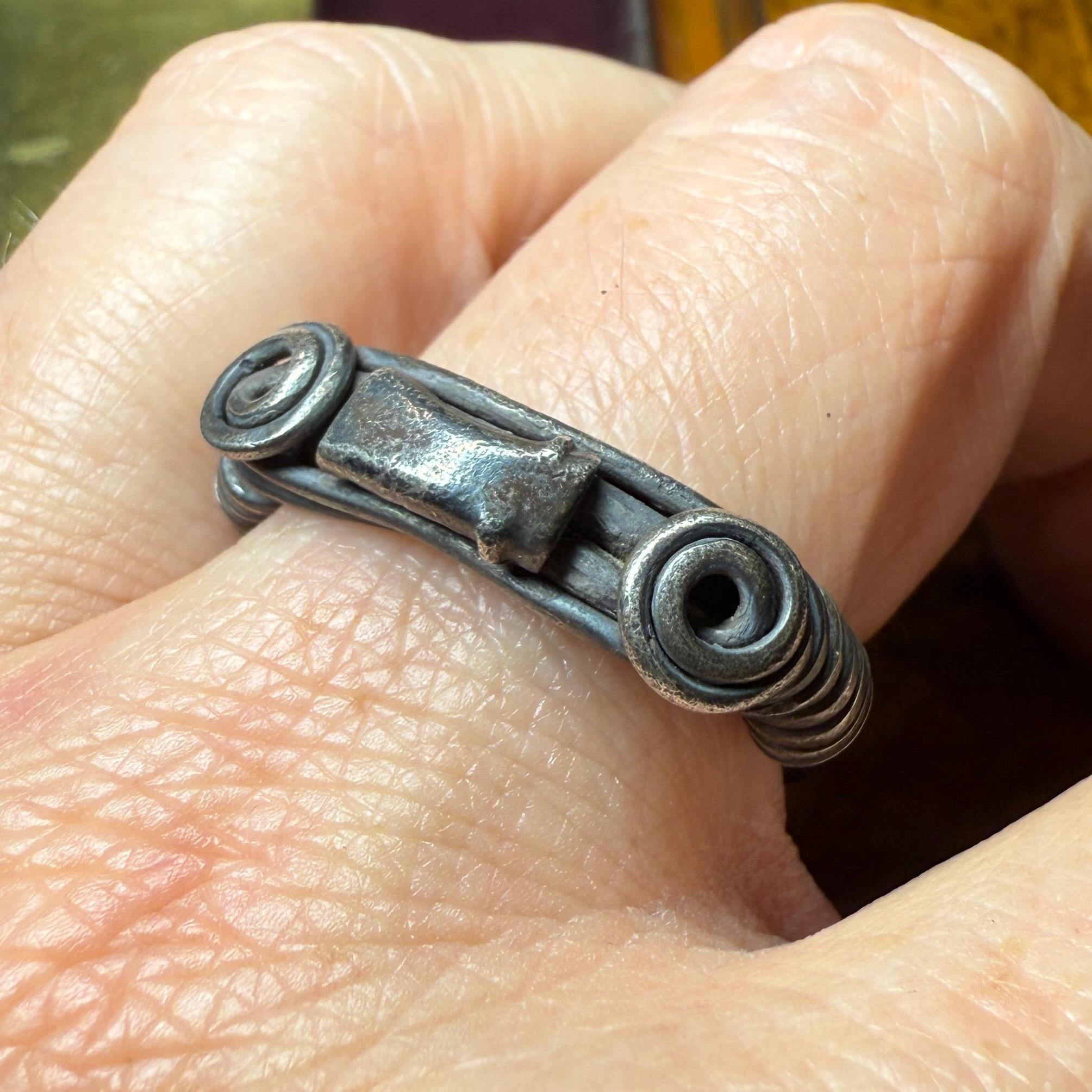 Silver Ring with Spiralled Terminals and Axe-Motif. Balkans, 1st–2nd century AD. In Good Condition For Sale In London, GB