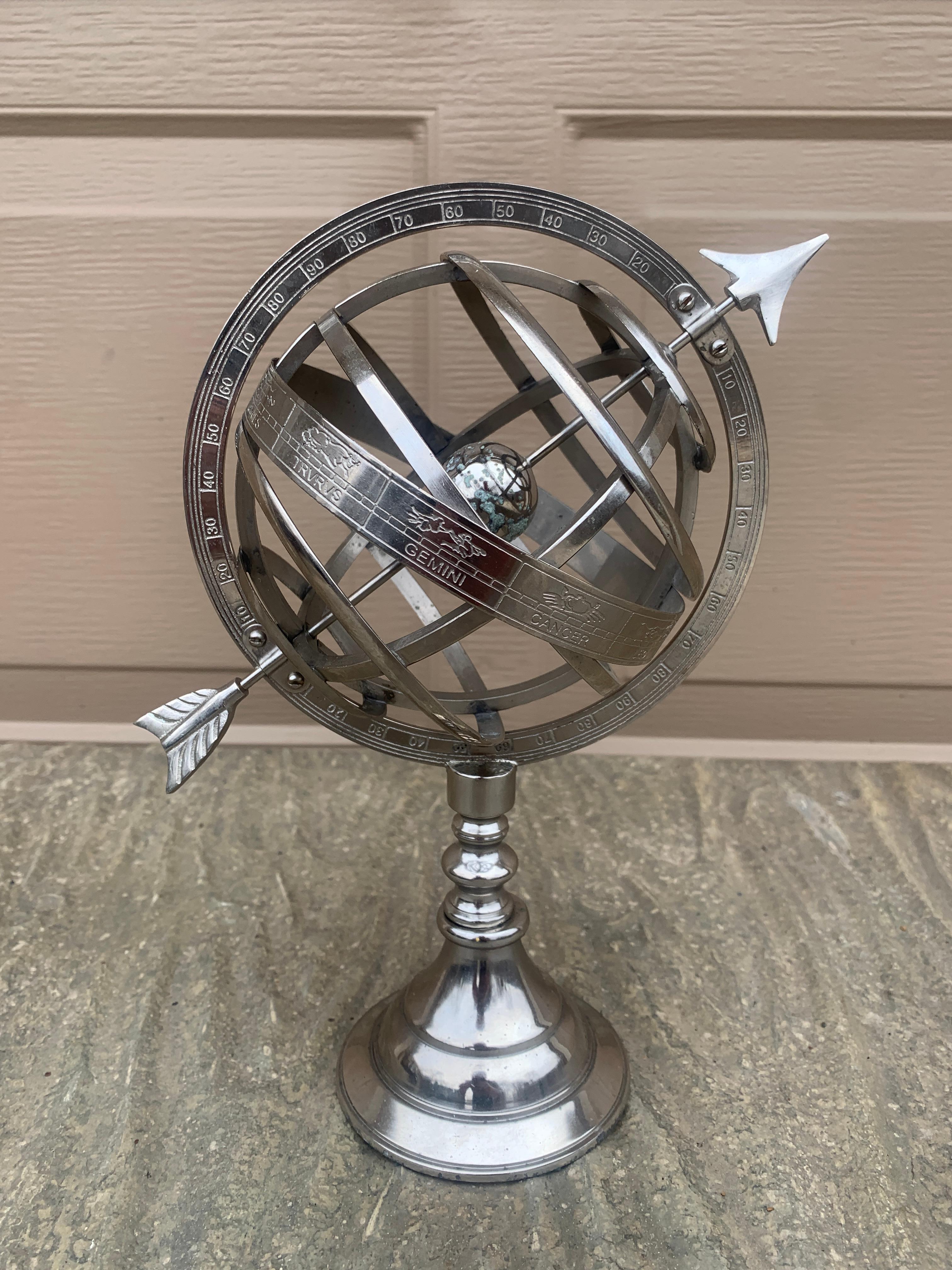 A stunning vintage silver metal armillary sundial featuring Roman numerals and the zodiac signs.

USA, Late 20th century.

Measures: 8.5