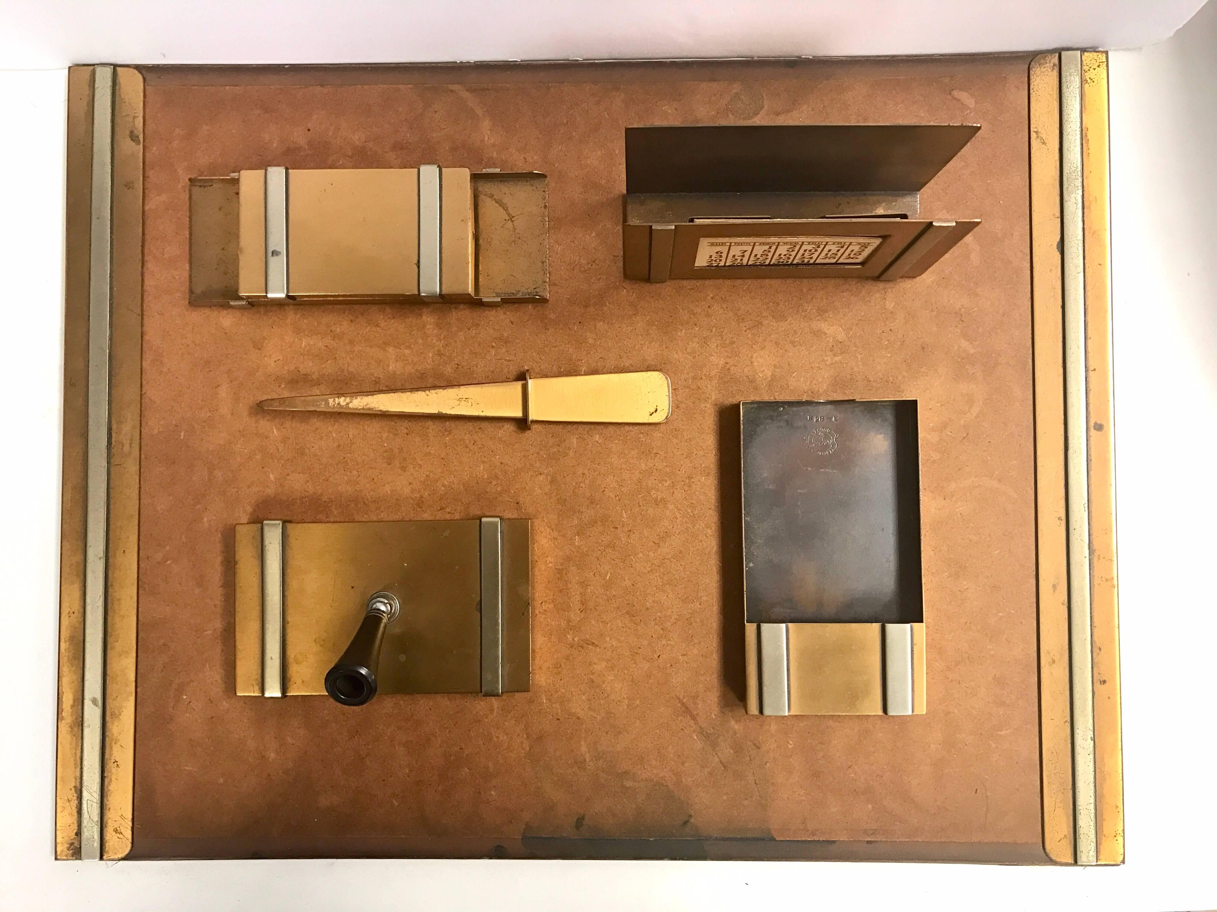 Art Deco bronze six-piece desk set from the 1930s by Silvercrest consists of a desk blotter, calendar holder or letter holder, pen holder, memo pad holder, ink blotter and letter opener. The writing pad measures 16 inches x 21 inches.