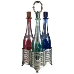 Antique Silvered Bottle Carrier and Three Coloured Glass Cordial Bottles