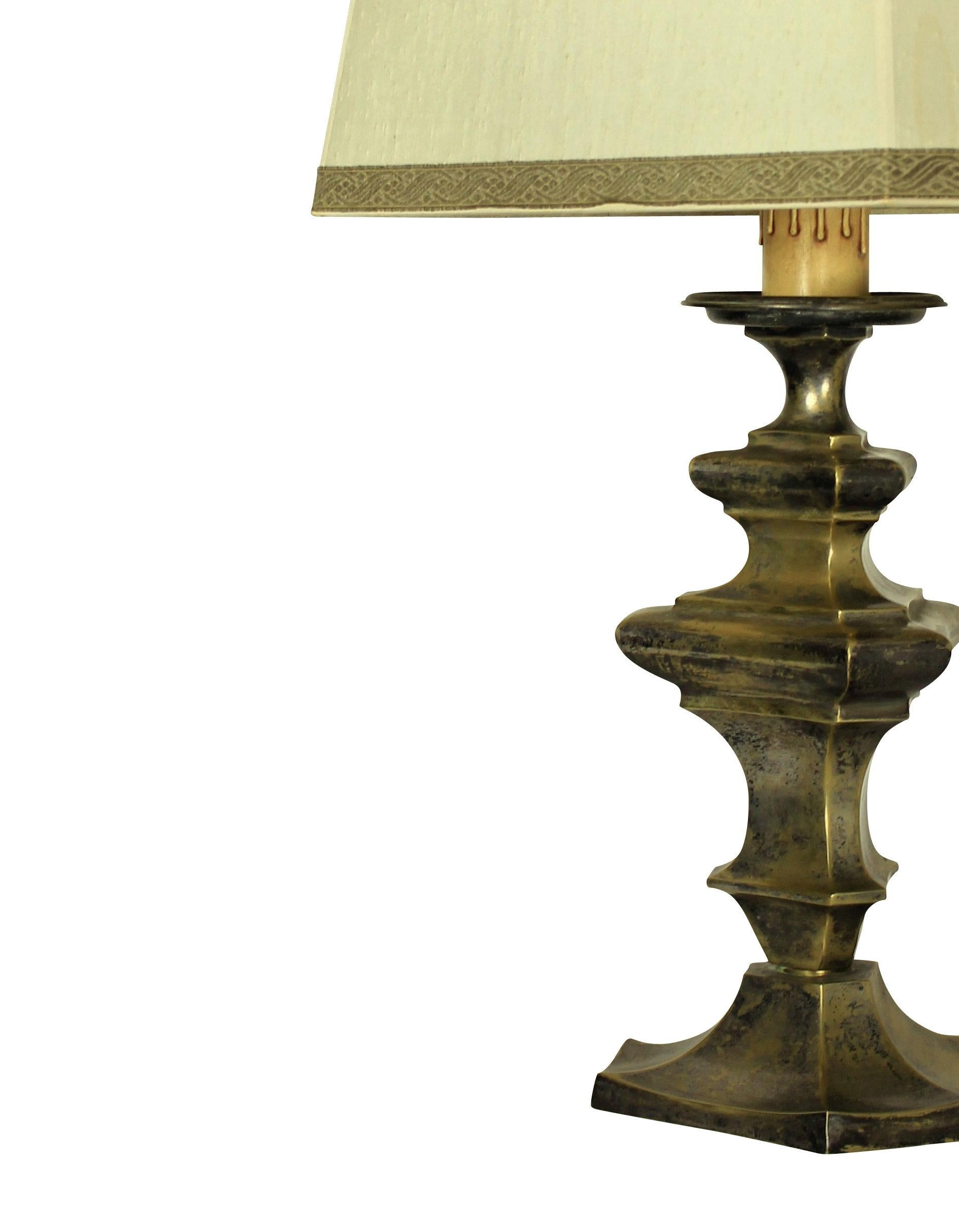 A Flemish lamp (formerly a candlestick) in silvered brass.