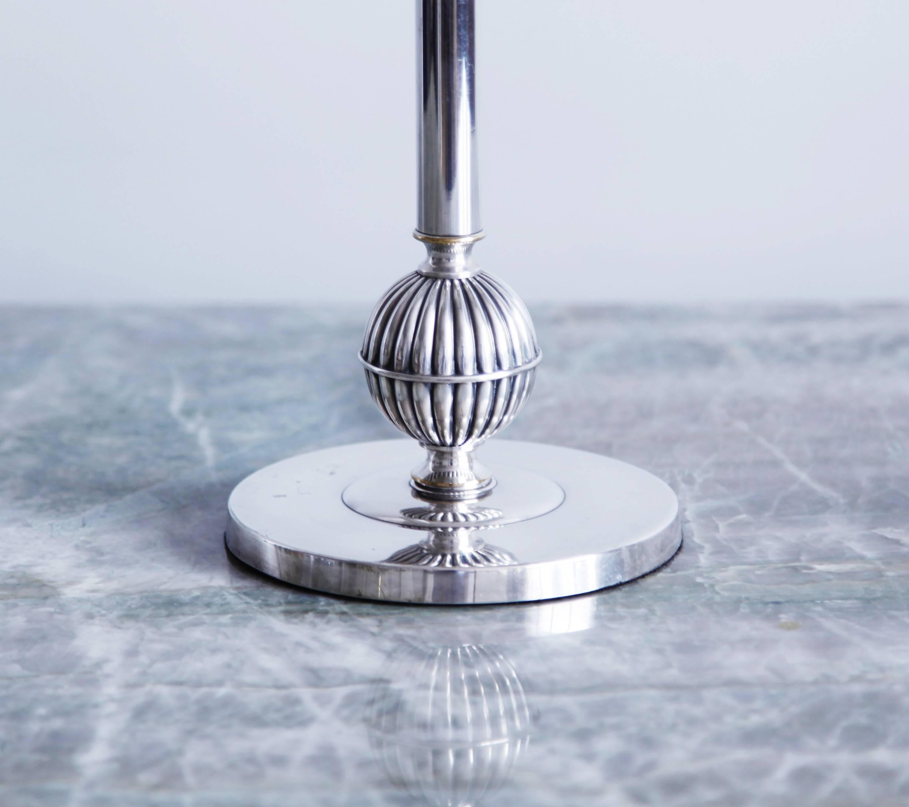 This Swedish Art Deco lamp was fabricated by the renowned silversmiths C.G. Hallberg. We love the fluted sphere of the base, and the excellent proportions. 

Rewired for use in the U.S.