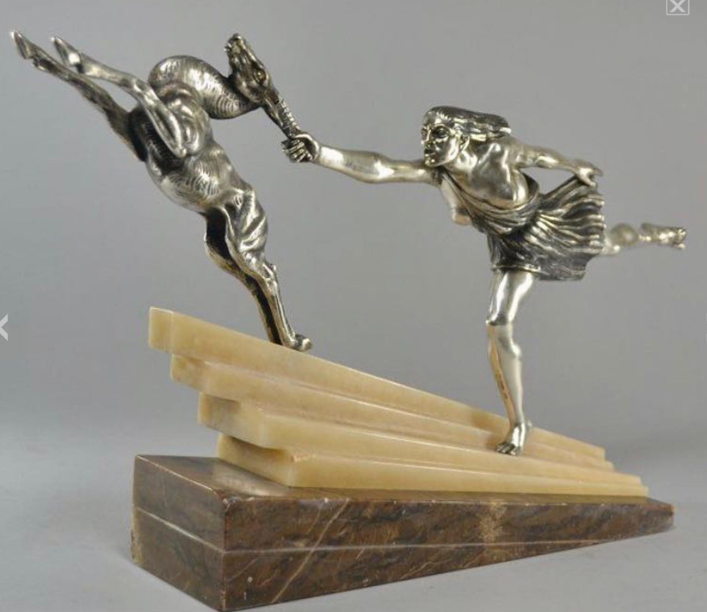 Silvered Bronze Art Deco Statue Pair featuring a woman reaching and grasping the antlers of a deer, a rare version of “Chasing the Hind” Designed by Aurore Onu French circa 1930. It has an outstanding classic and cubist design, with a female figure
