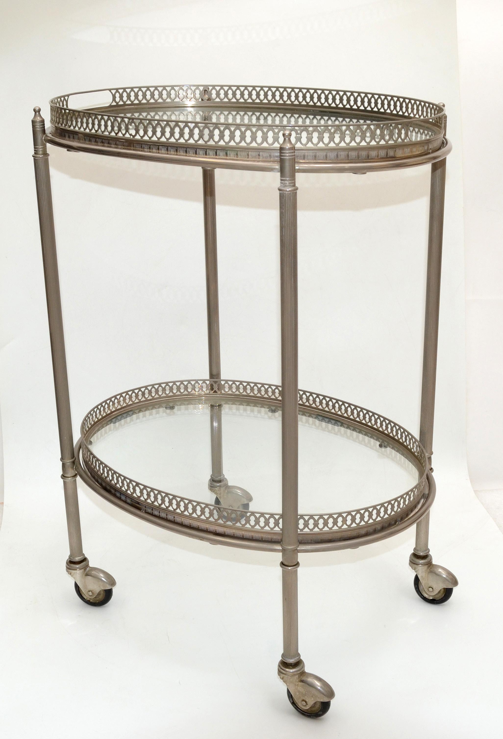 Very attractive Maison Lancel silvered bronze 2 tray oval bar cart. 
Both trays are removable. 
Finely cast galleries give this piece a neoclassical flair.
All original wheels which run smoothly.
Measures: Space from the floor to the top shelf