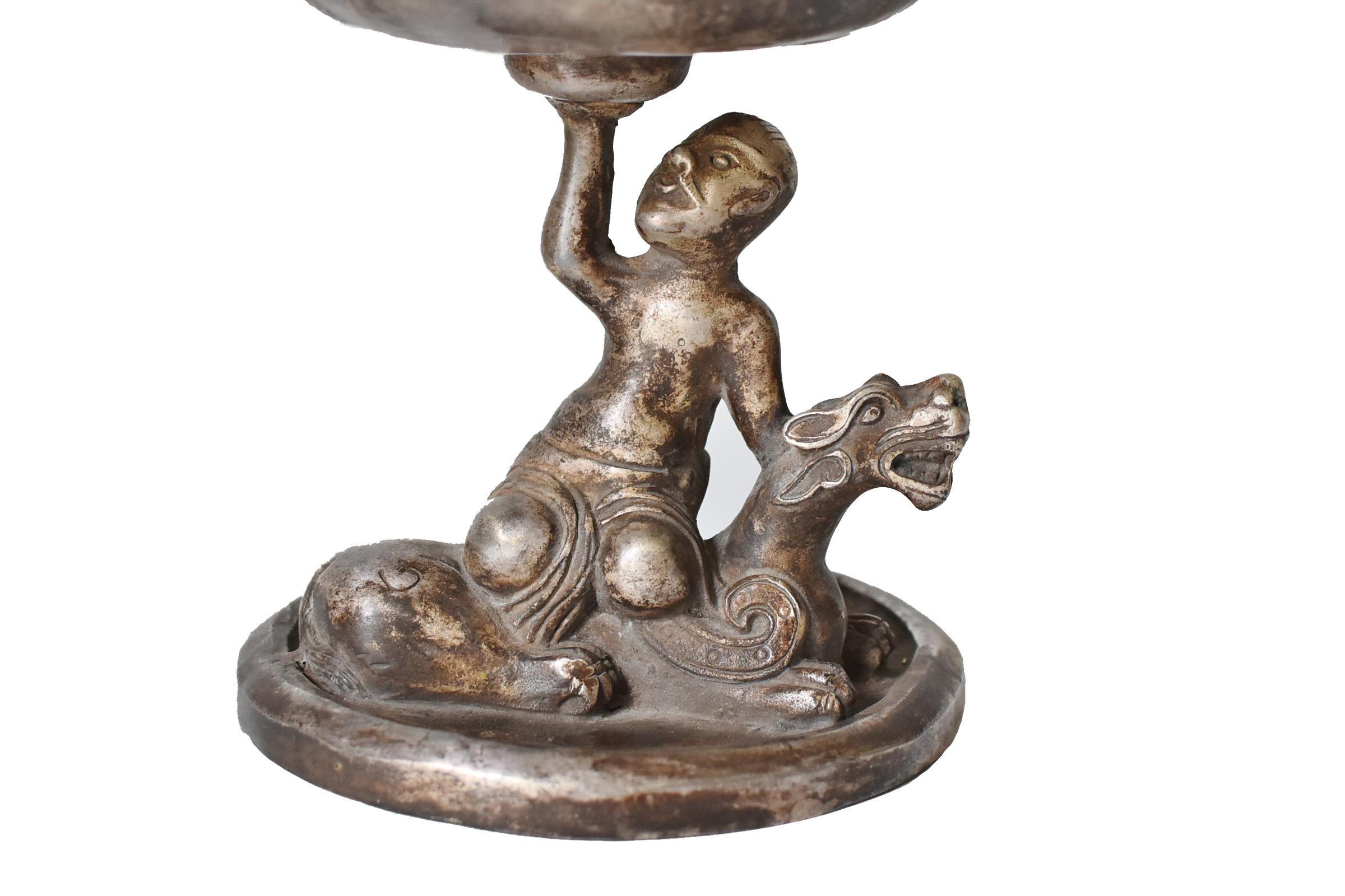 A beautiful silvered bronze 20th century Bo Shan incense burner featuring a boy riding on a dragon. The lid of the burner resembles cloud covered summit of mountain, hence the name 
