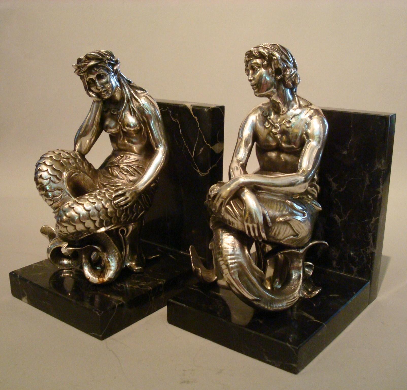 Silvered bronze bookends sculptures of a Mermaid and Merman, France, 1900.
This enchanting bronze sculpture is the object of many sailors dreams. Silvered bronze sculptures of a mermaid and merman. A female figure, nude from the waist up, boasts a