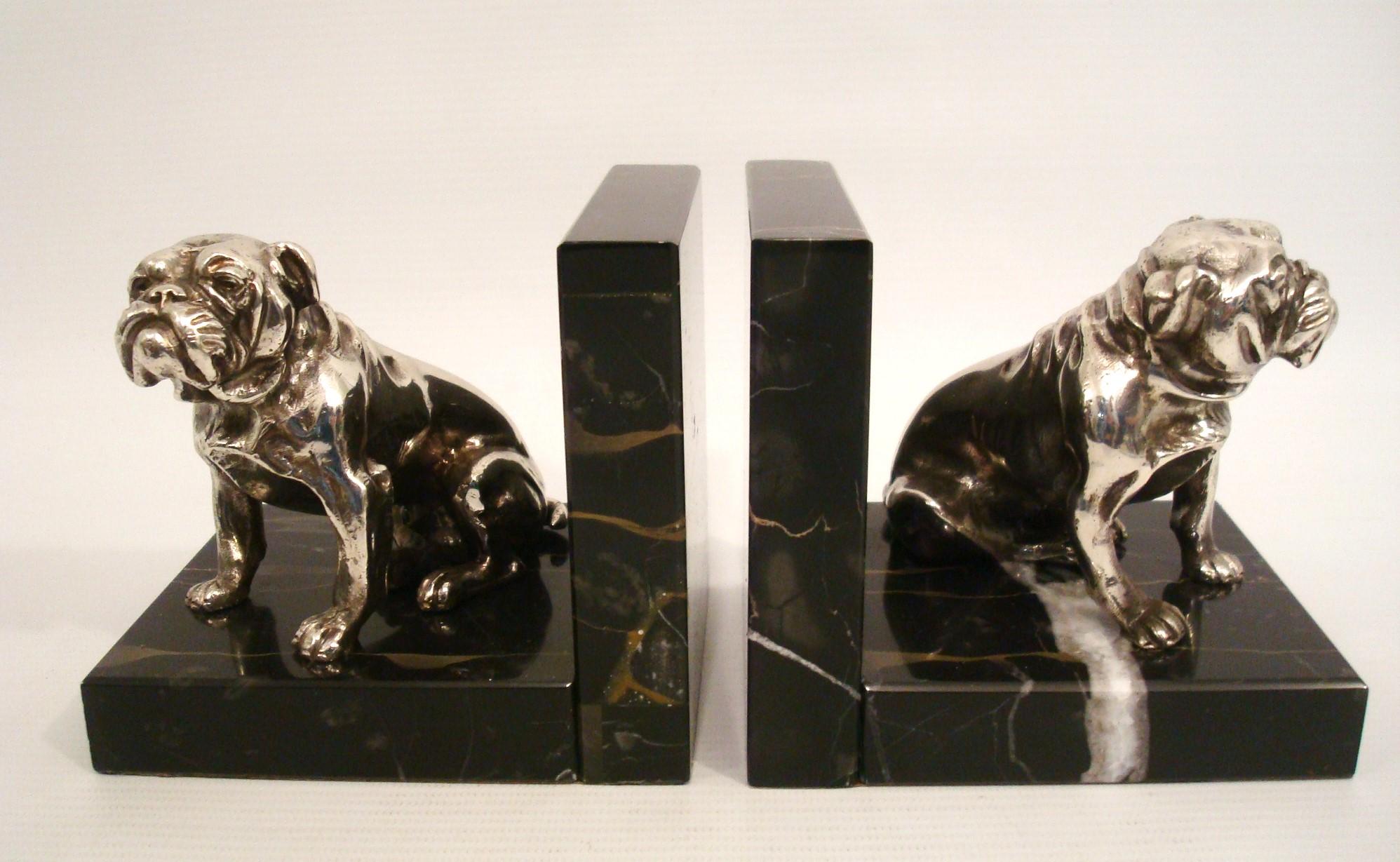 Silvered Bronze Bulldog Bookends. c1930´s.
Lovely pair of Bulldog bookends. Silvered Bronze mounted over Black and Gold ¨portoro¨ italian marble. Very nice details on the dogs.

We have specialized in the sale of Art Deco and Art Nouveau and Vintage