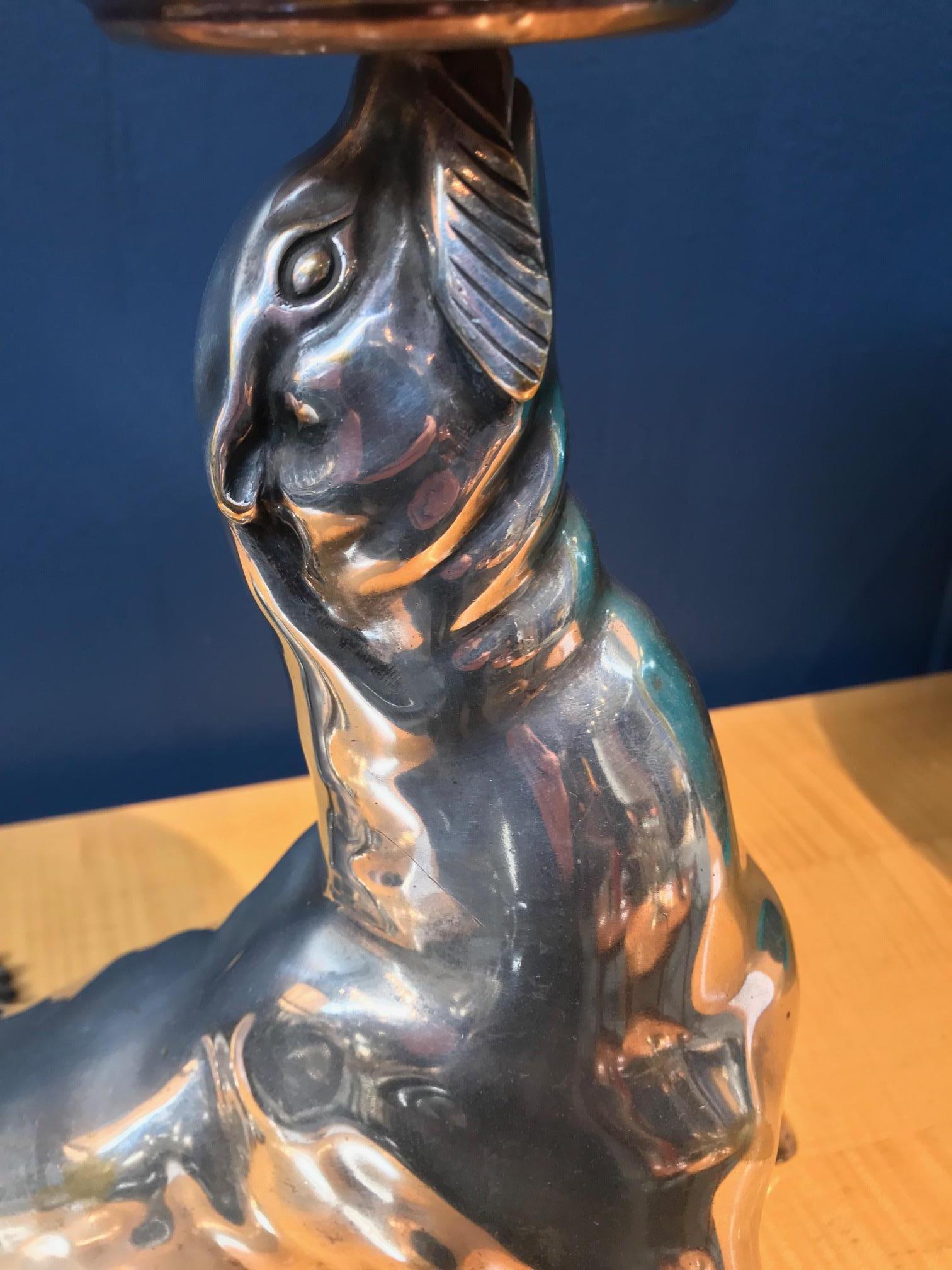 Silvered bronze illuminated sculpture representing a seal holding an onyx ball
Signed: “Bourcart” 
    




