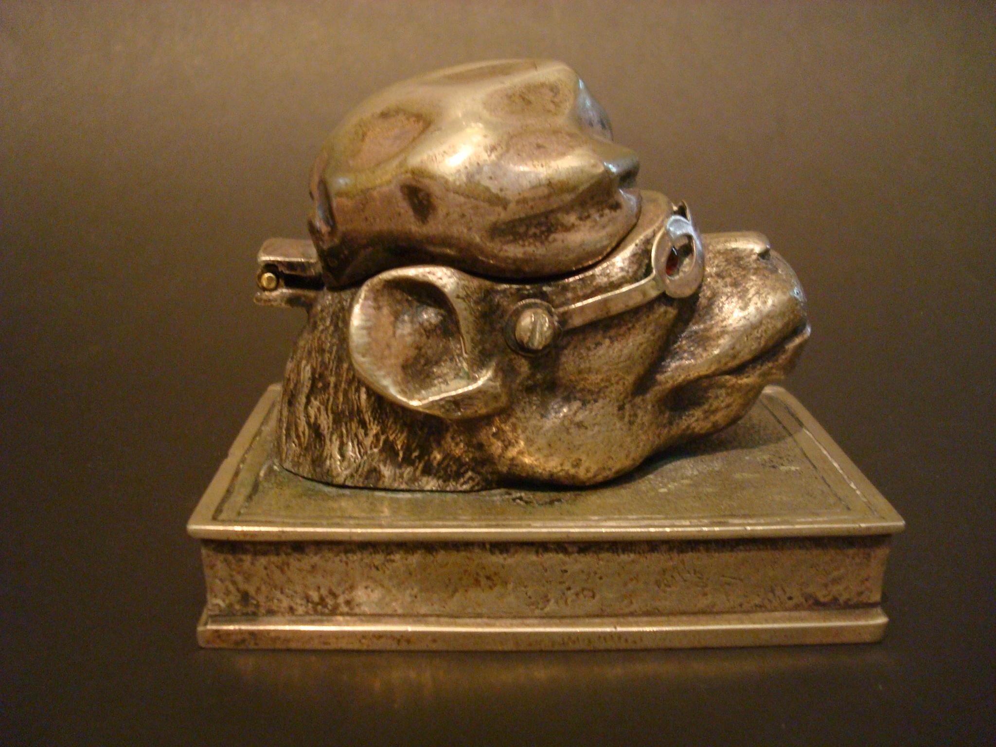French bronze inkwell, zoomorphic inkwell in the form of a monkey head in a hinged nightcap, with glass eyes
bronze ink well statue in the form of a of a monkey wearing a hat with a clear glass ink pot and glass eyes.