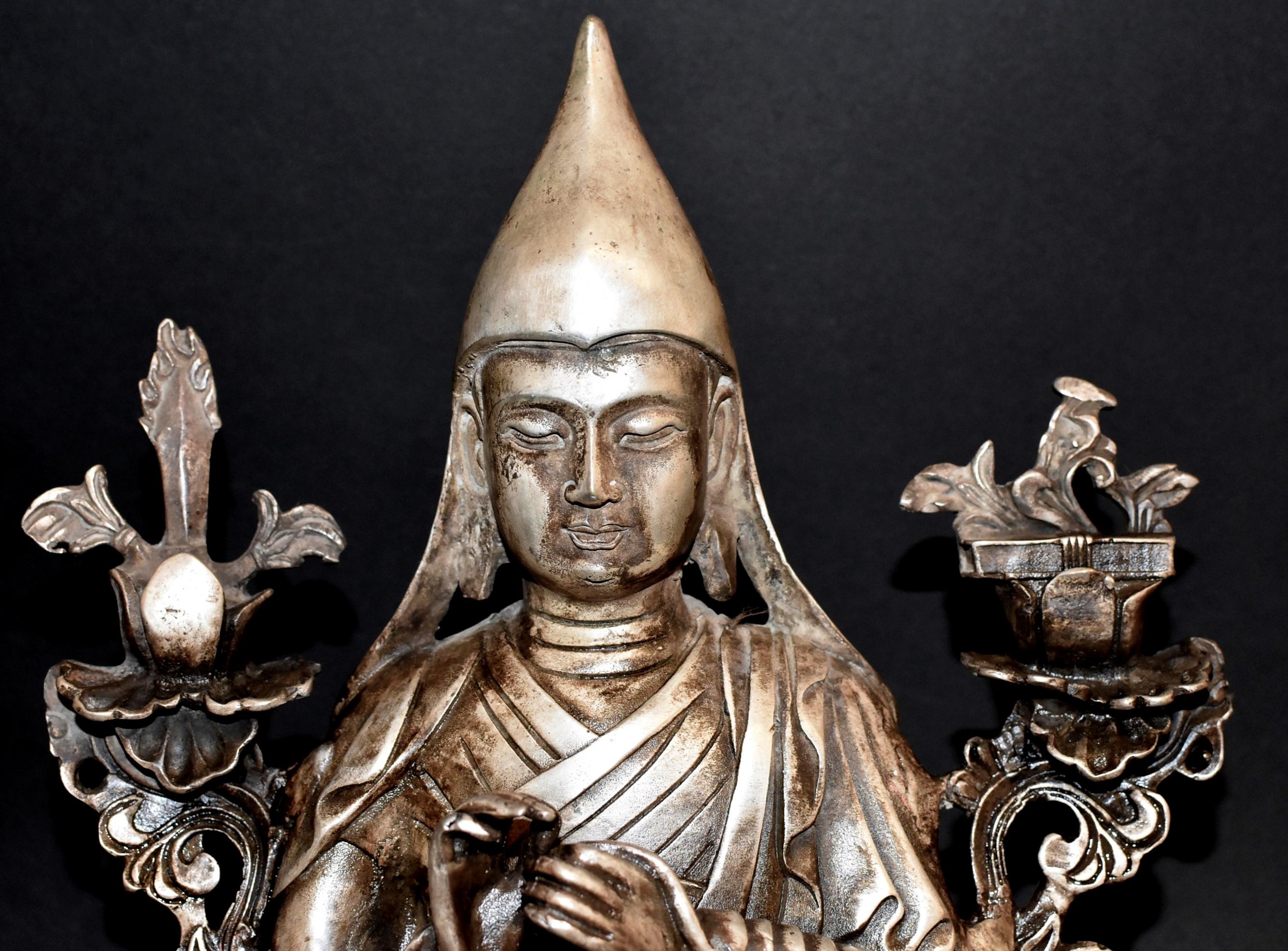 A fine silver bronze statue of the Tibetan teacher Tsongkhapa. Je Tshongkhapa is the teacher of Tibetan Buddhism whose activities formed the Gelug school of Tibetan Buddhism. He is believed to be the reincarnation of God of wisdom. The statue