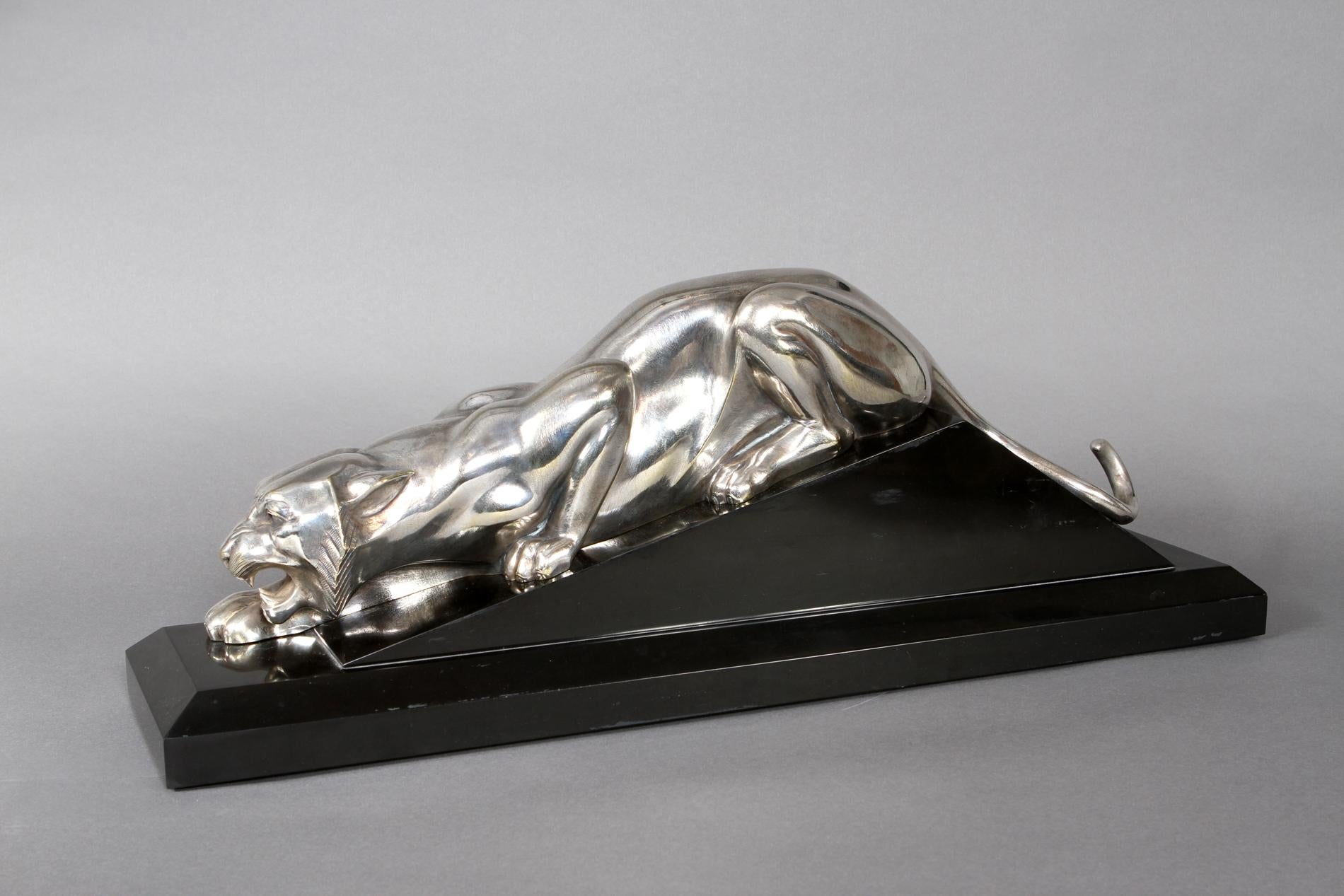 Silvered bronze sculpture representing a tiger by Georges Lavroff standing on a black marble base. 
The sculpture is part of the book 