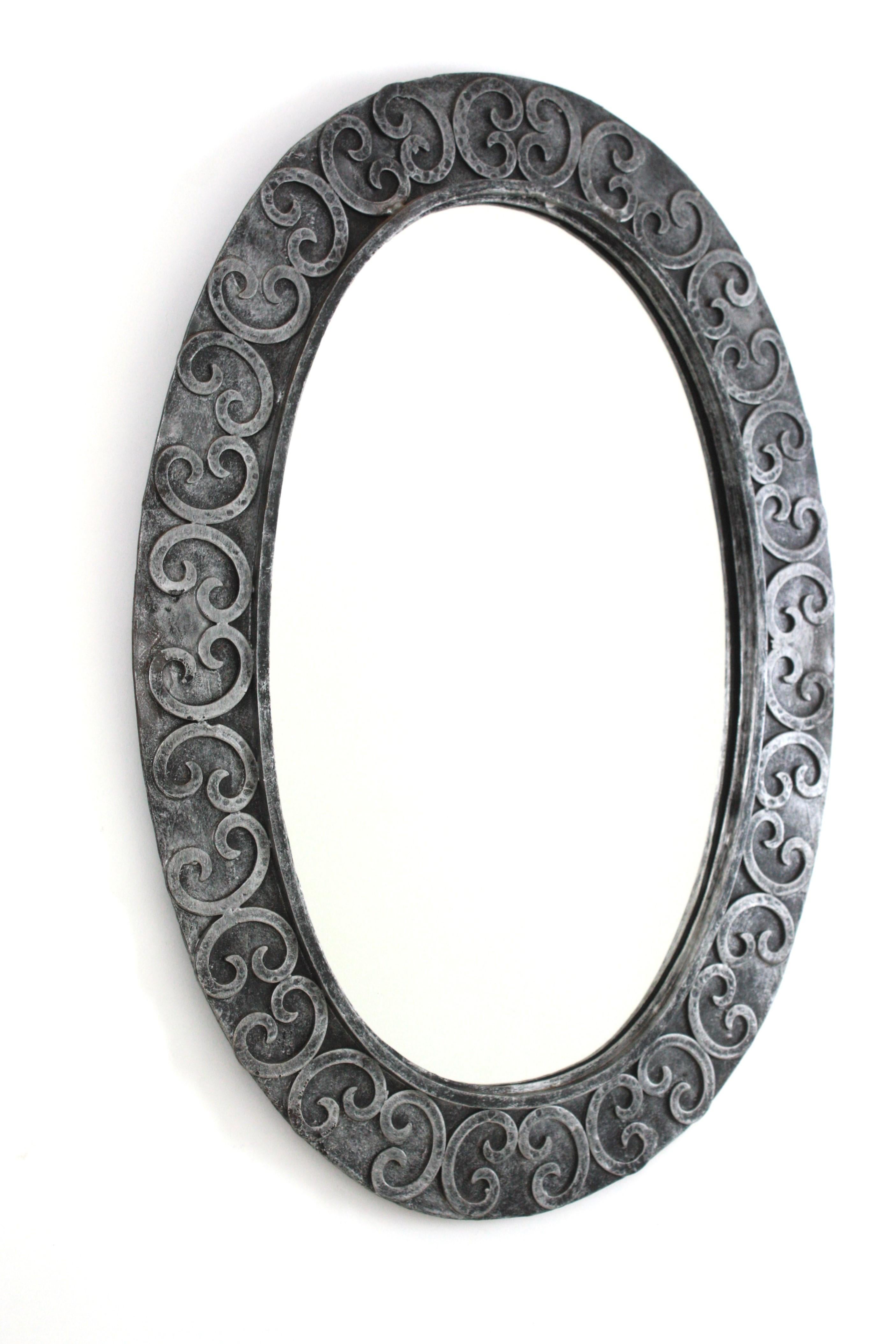 Spanish Silvered Brutalist Oval Mirror in Wrought Iron with Scroll Decorations For Sale