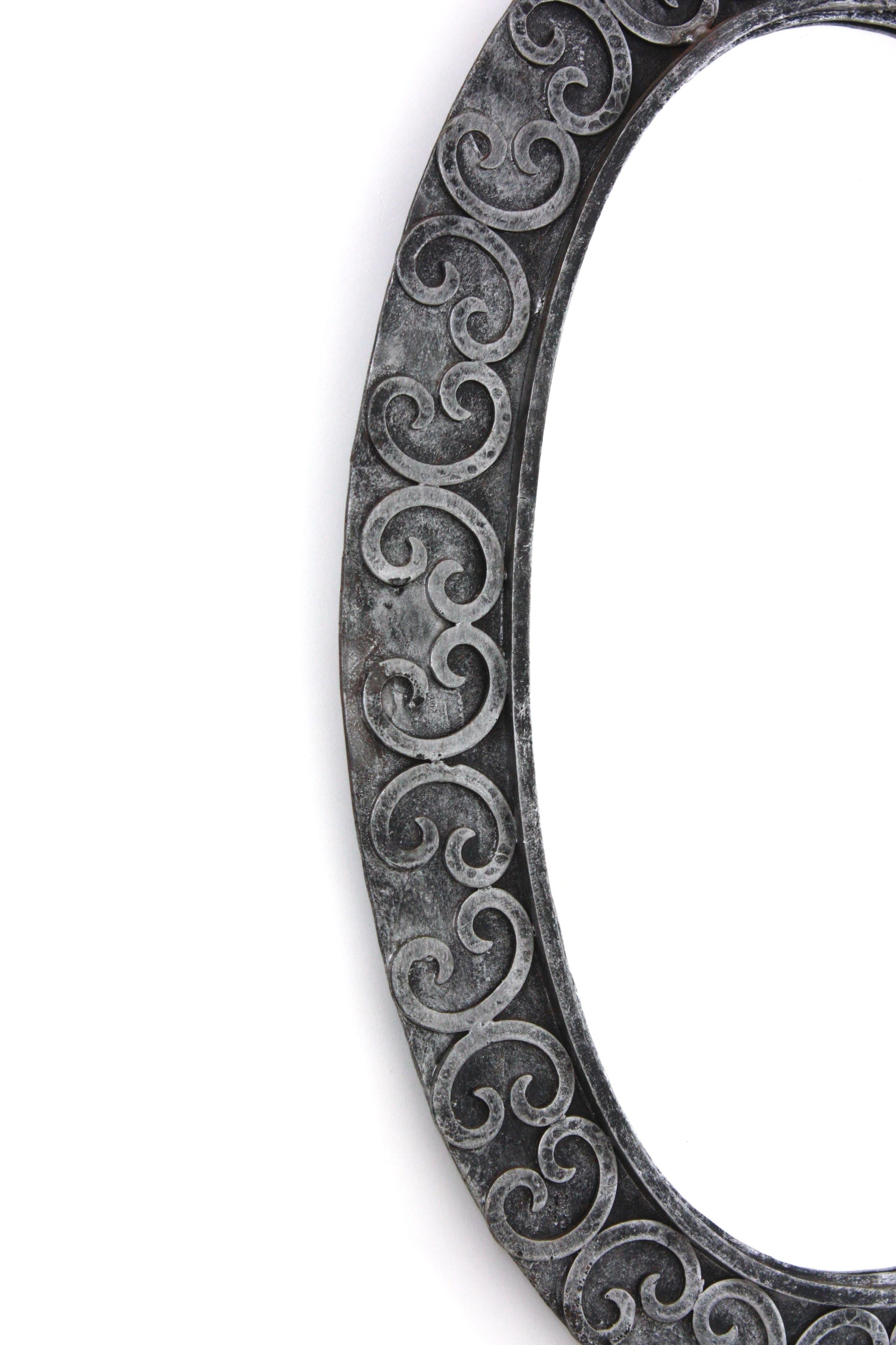 Forged Silvered Brutalist Oval Mirror in Wrought Iron with Scroll Decorations For Sale