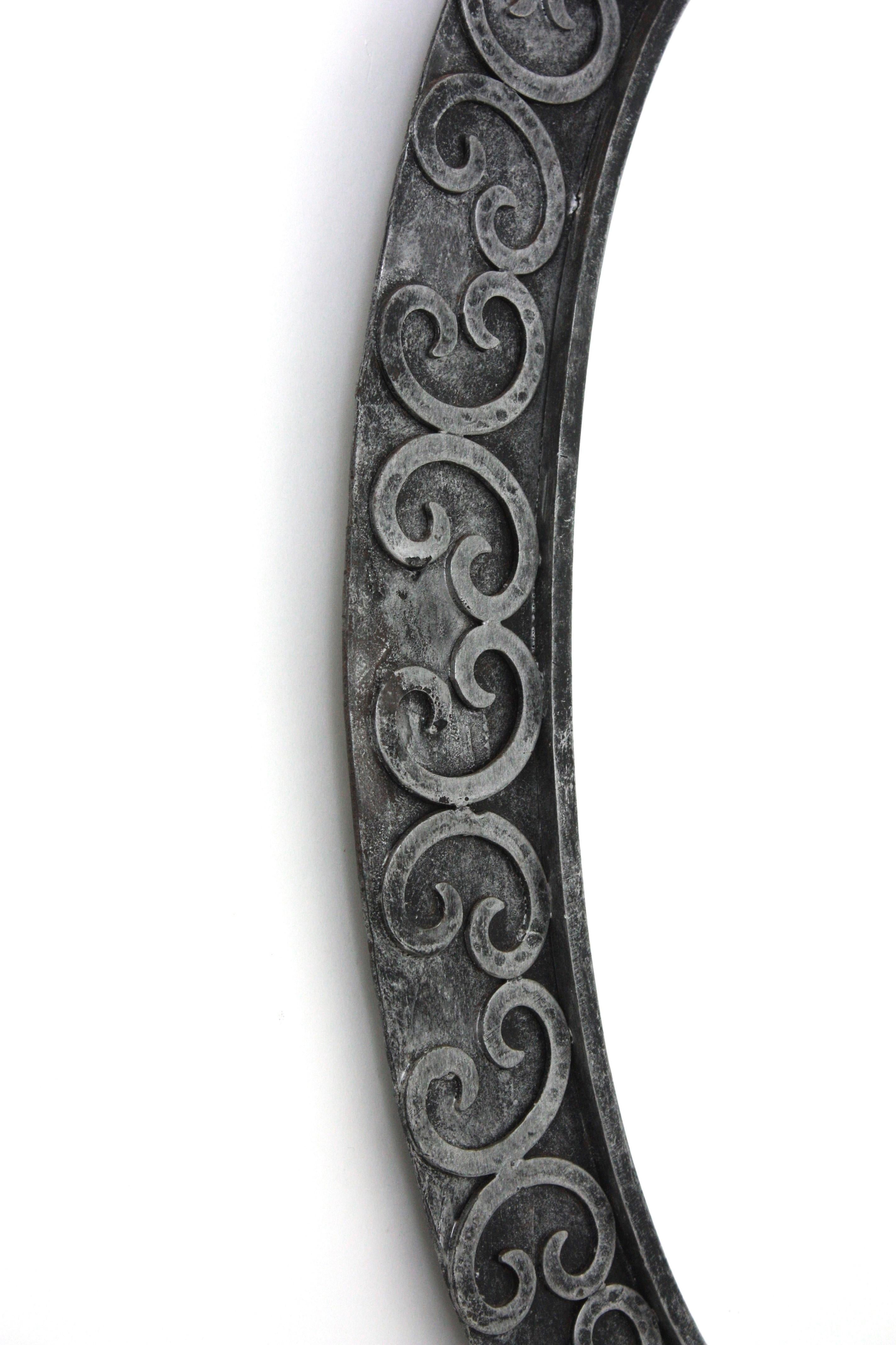 20th Century Silvered Brutalist Oval Mirror in Wrought Iron with Scroll Decorations For Sale