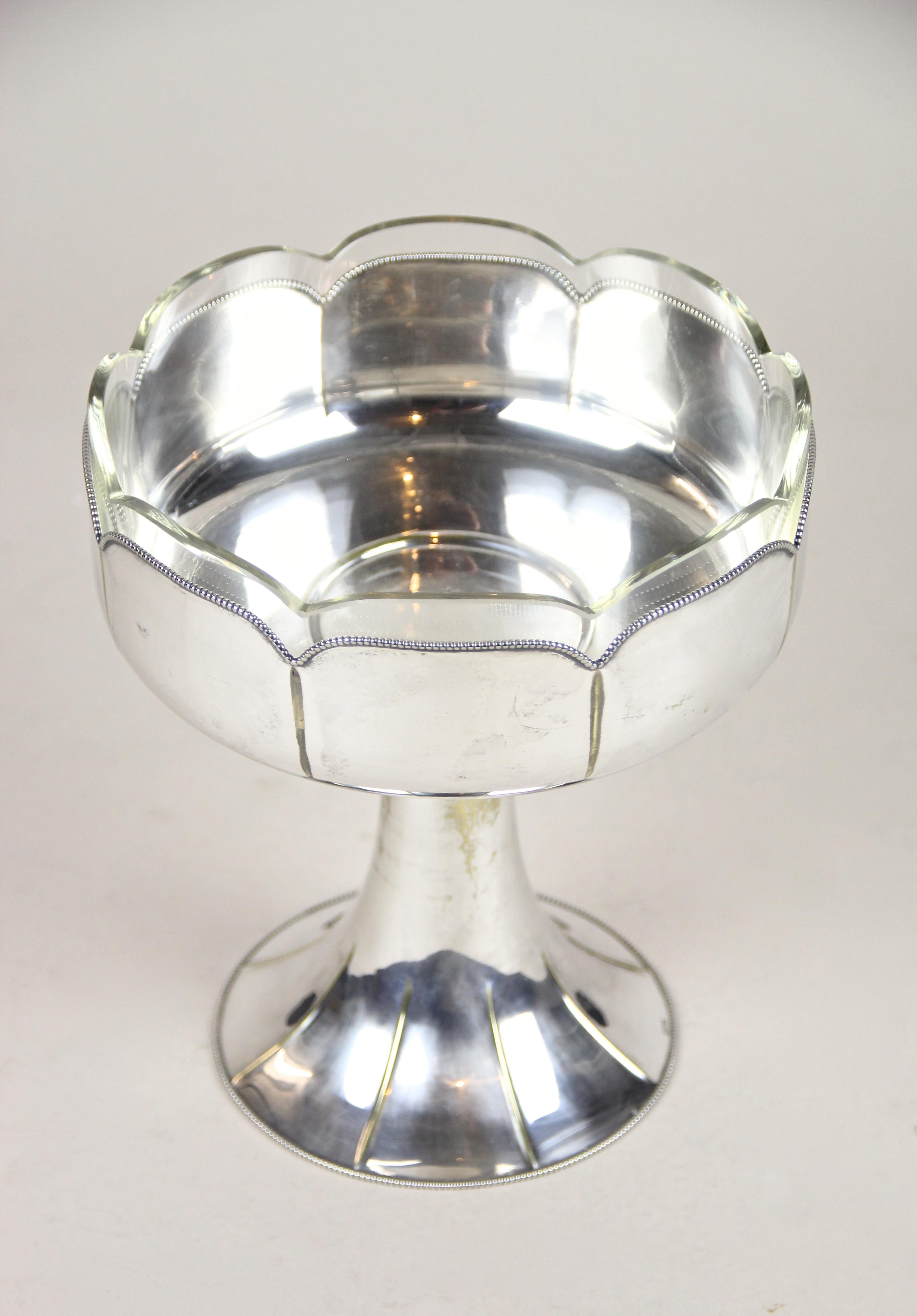 Charming silvered centerpiece with glass bowl from the famous German Company of WMF out of the Art Deco period circa 1920. A great designed centerpiece made of silvered brass and showing typical age related abrasions. Enthroned on the lovely shaped
