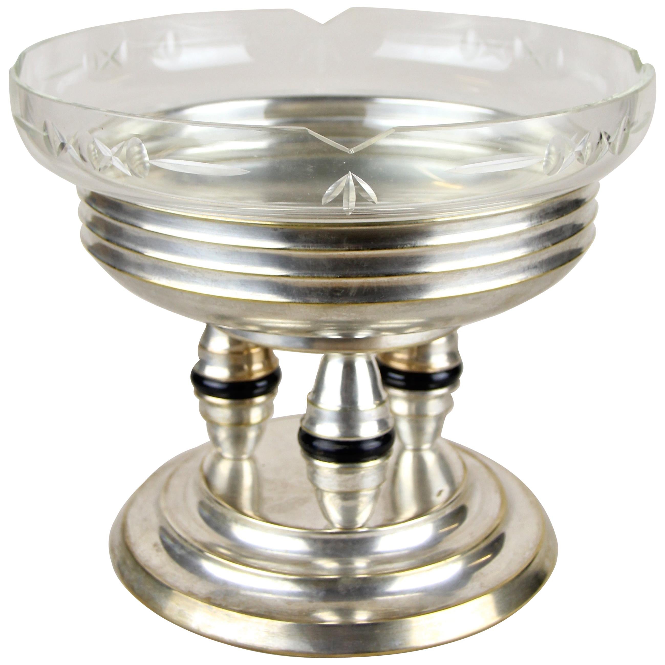 Stunning silvered centerpiece with glass bowl made by the company Lenk in Austria around 1920. The lovely designed base was artfully made of silvered brass. Enthroned on three unusual shaped short columns with black ring applications, sits an