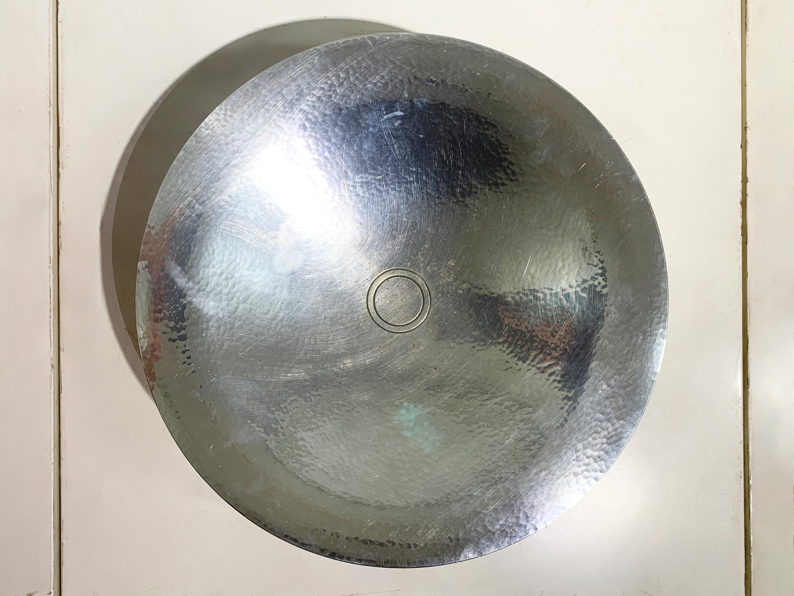 A stunning and monumental Art Deco coupe or serving dish, a masterful work of design by Luc Lanel for the prestigious French house Christofle, circa 1933.

This piece perfectly embodies the geometric elegance of the Art Deco era. The shallow, wide