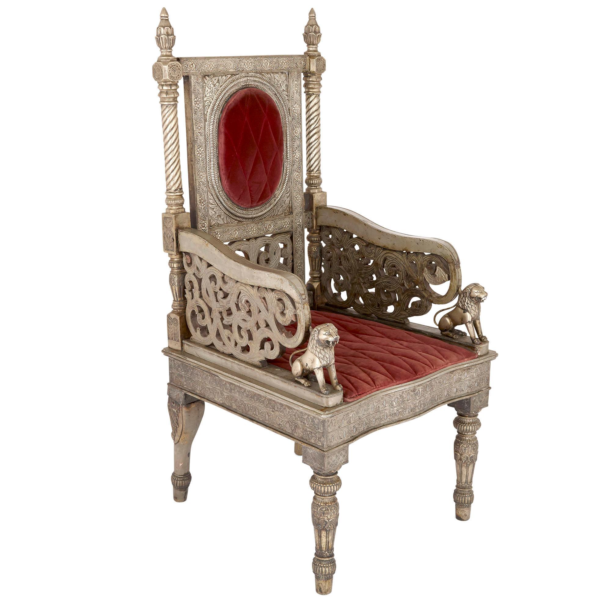 Silvered metal and red velvet throne chair
Indian, circa 1880
Measures: Height 138cm, width 66cm, depth 66cm

This fine Indian throne chair would have been popular in Europe as well as India in the 19th century. The detailed silvered metal chair