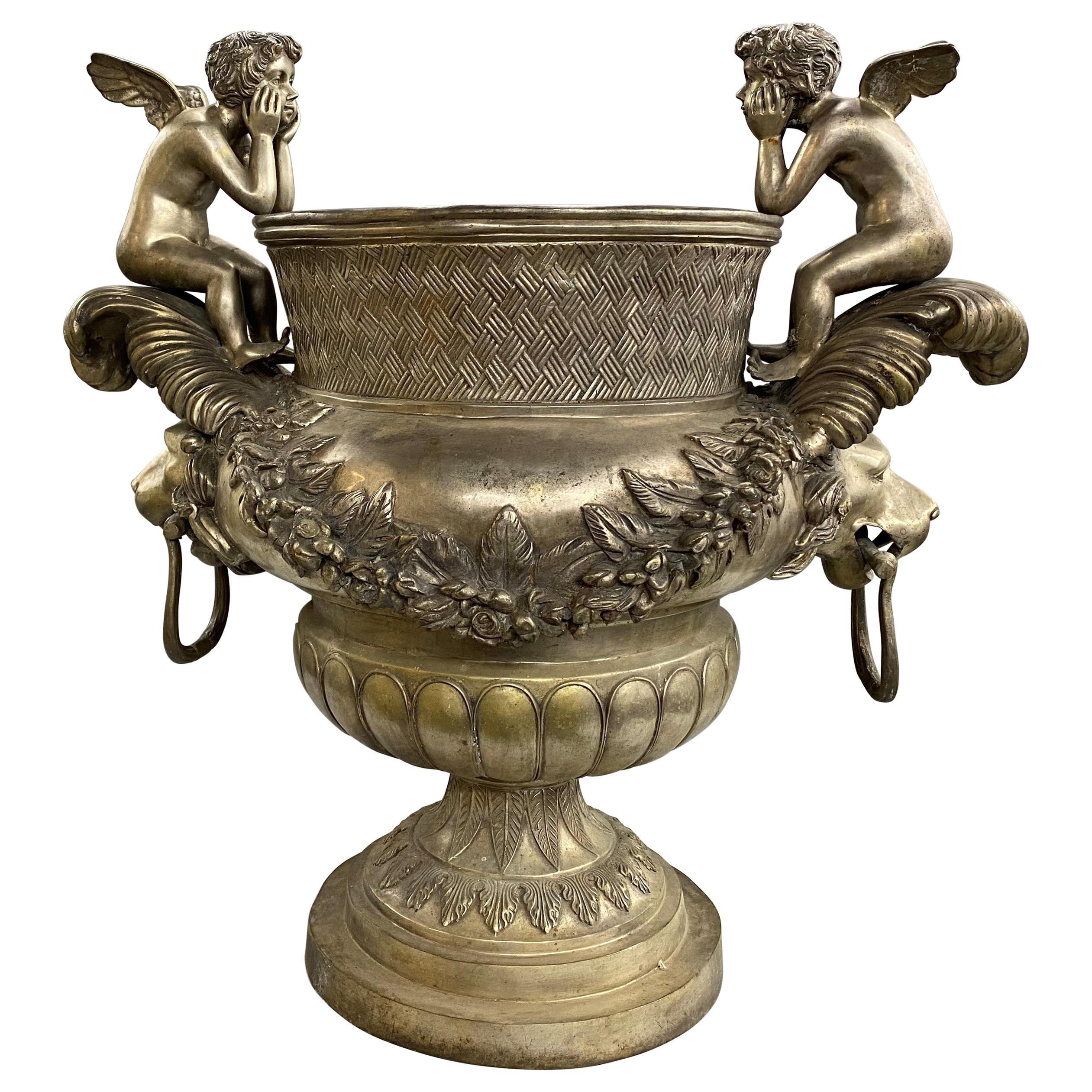 Silvered Metal Handled Garden Urn with Lion Heads and Winged Putti