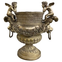 Silvered Metal Handled Garden Urn with Lion Heads and Winged Putti