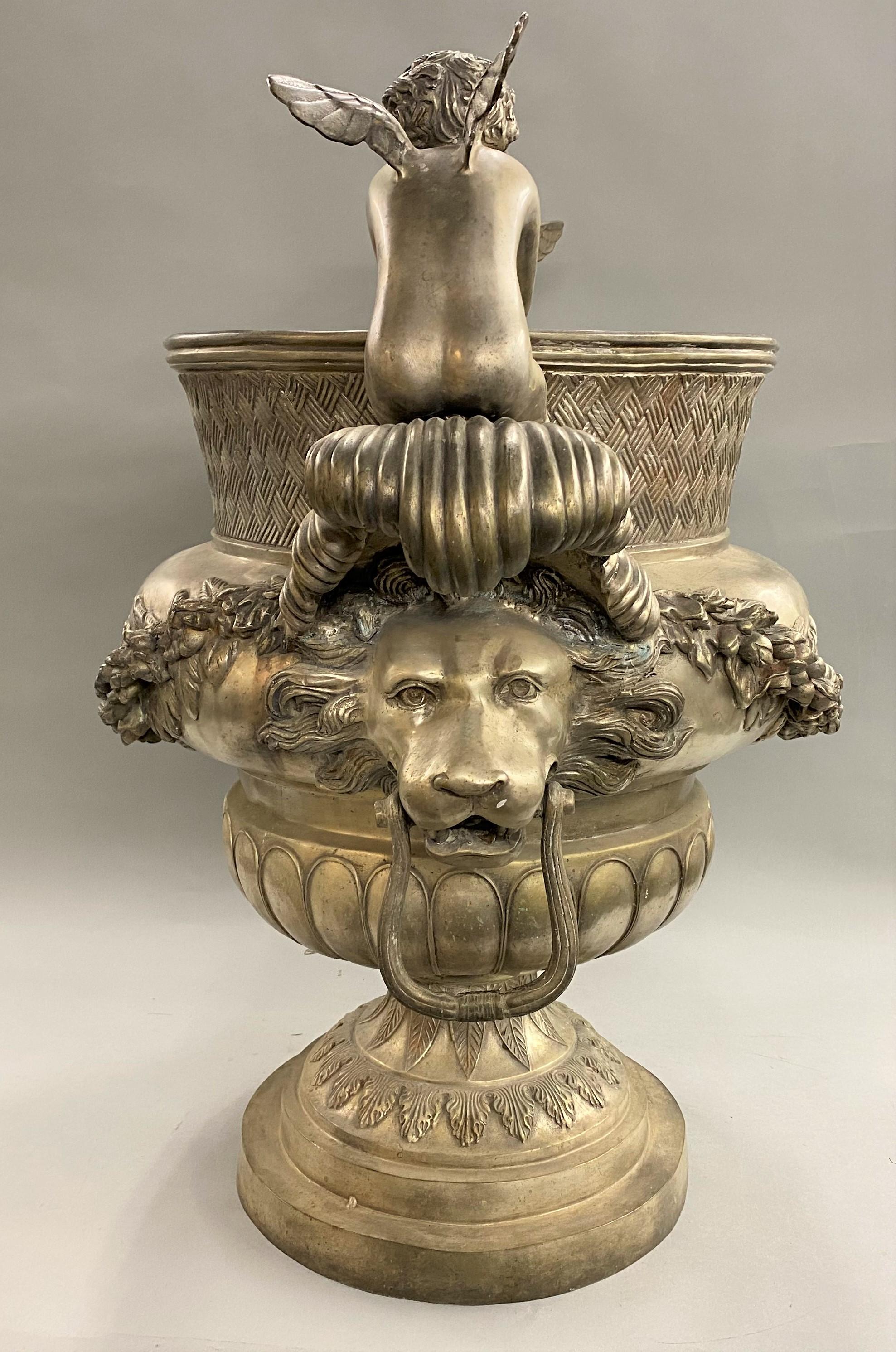 20th Century Silvered Metal Handled Garden Urn with Lion Heads and Winged Putti