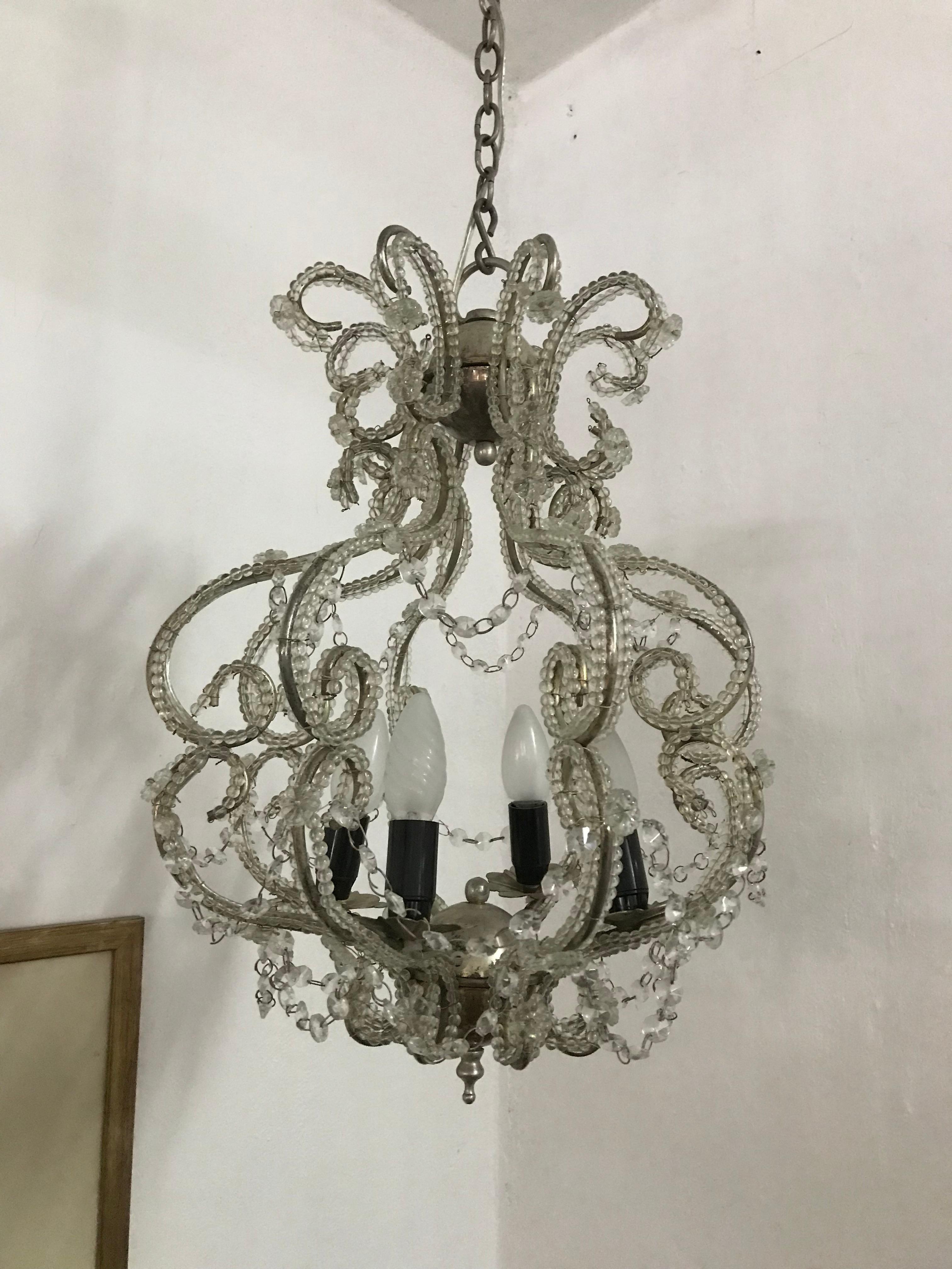 French chandelier, in silver gilt steel, beaded throughout all the metal work with cut glass beads. Made in France, circa 1960.