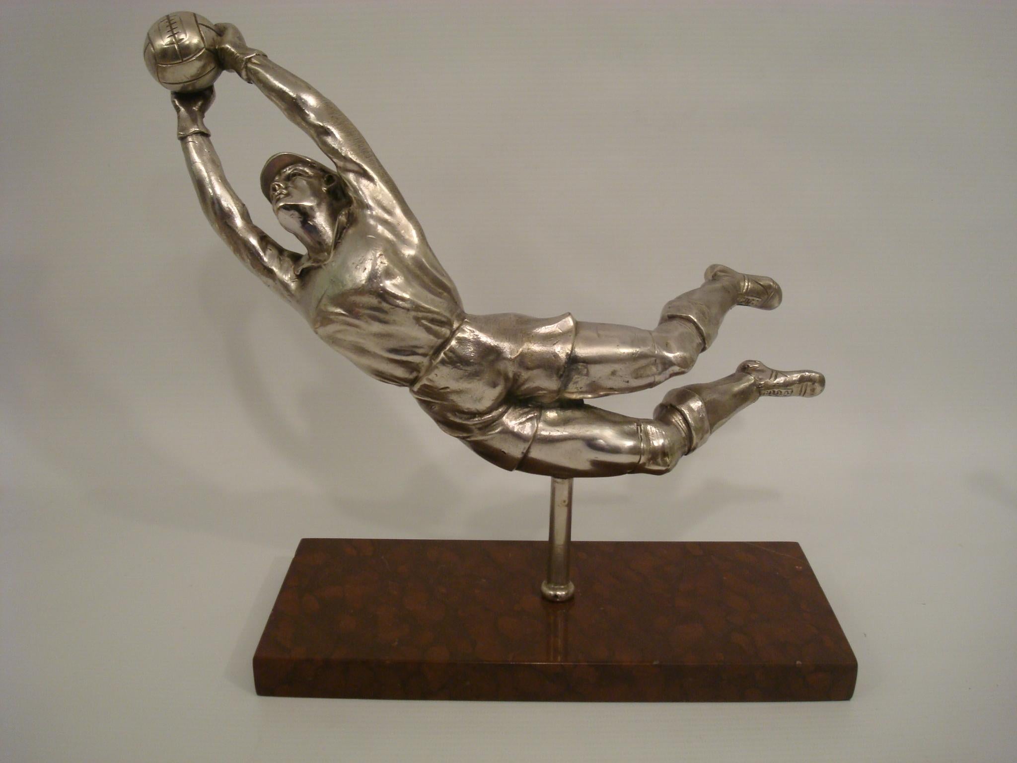 A silvered spelter figure of a diving football Player, soccer goalkeeper France, circa 1940, signed E. Drouot. Silvered metal set over a marble base.
Perfect for a trophy.

 