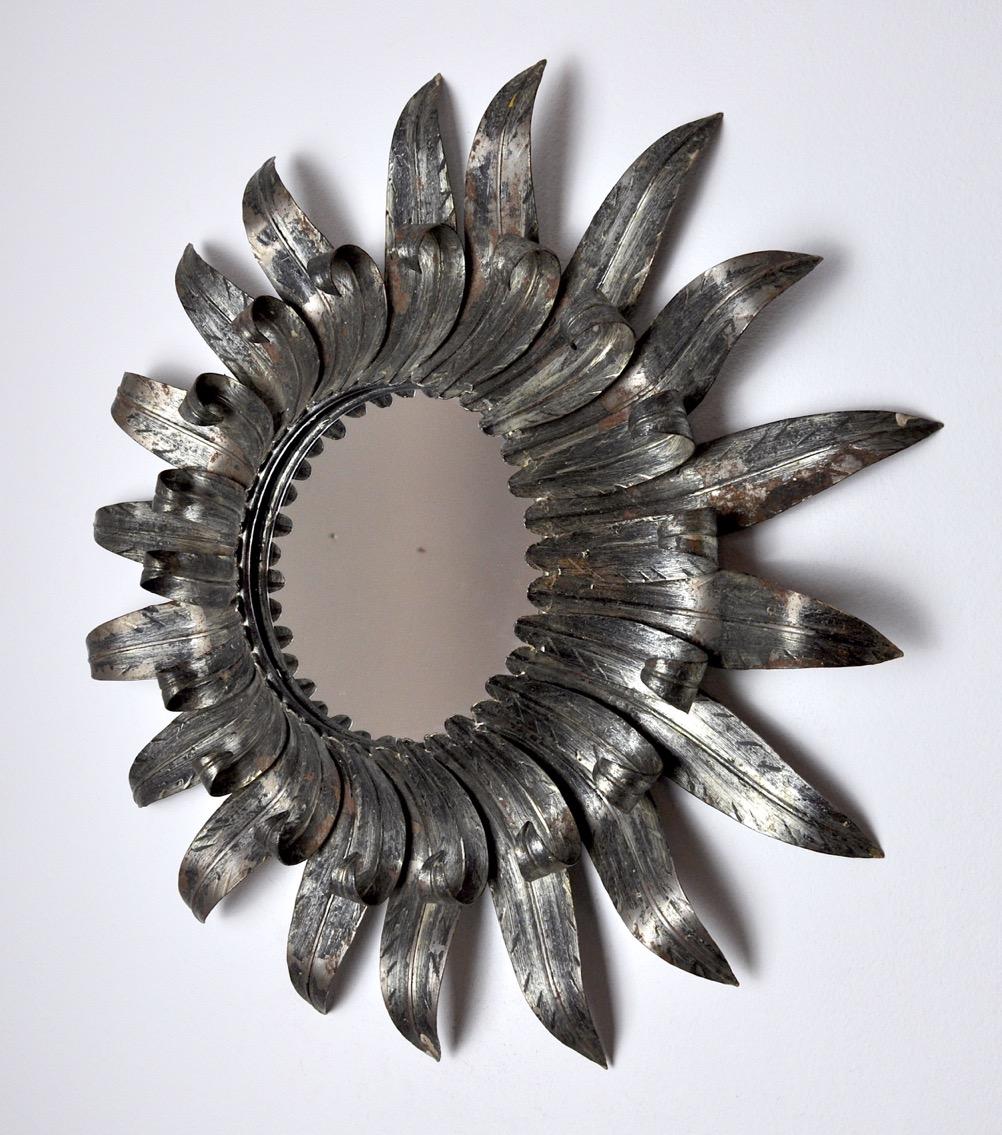 Superb and rare silver sun mirror with silver leaf designed and produced in Italy in the 1970s. Very fine forge work, superb dimensions, unique object which will decorate and bring a real designer touch to your interior.

