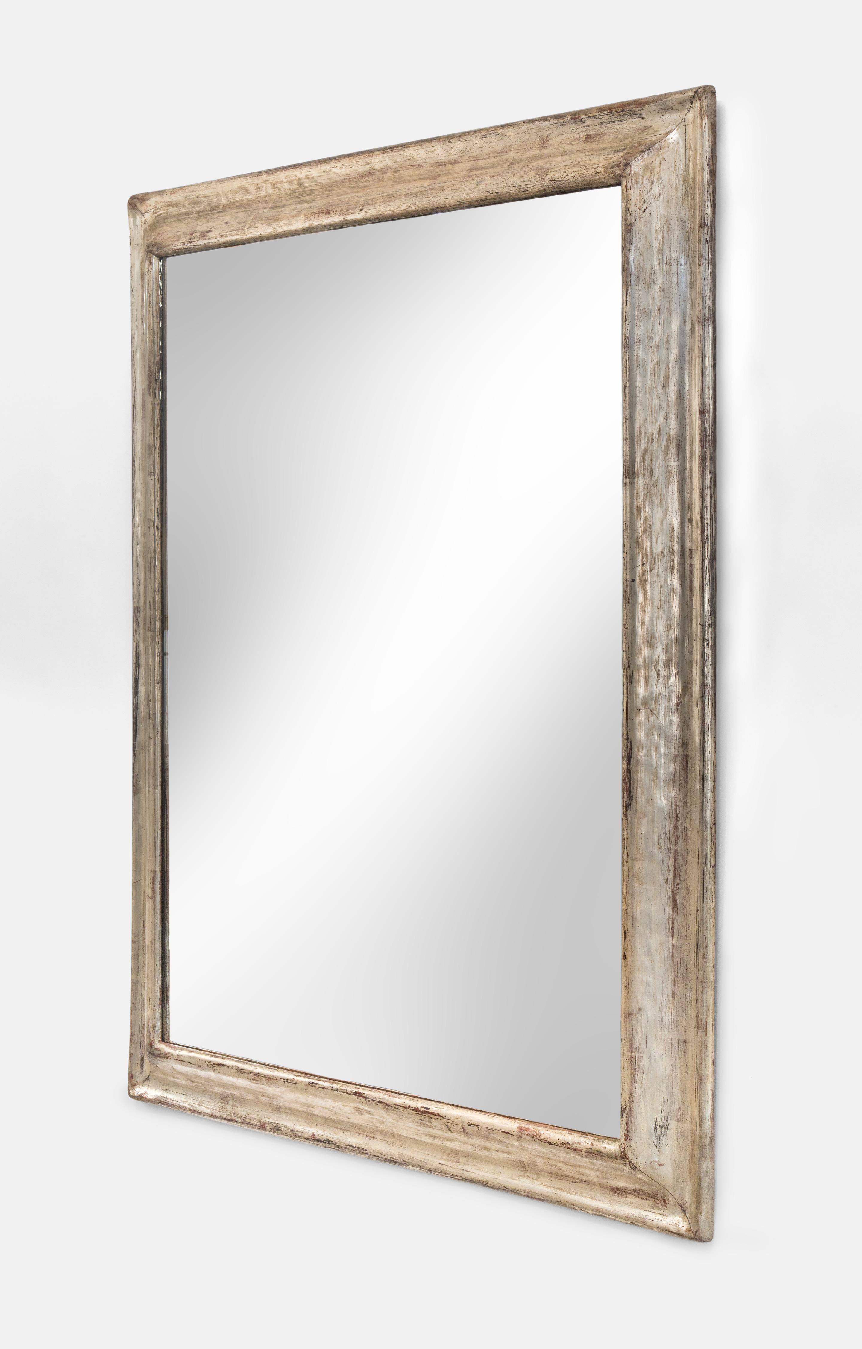 Silvered wooden frame mirror
20th century
A very pretty mirror of handsome scale; all that it reflects will look more attractive. The mirror glass within a molded wood frame with antiqued silvered finish.