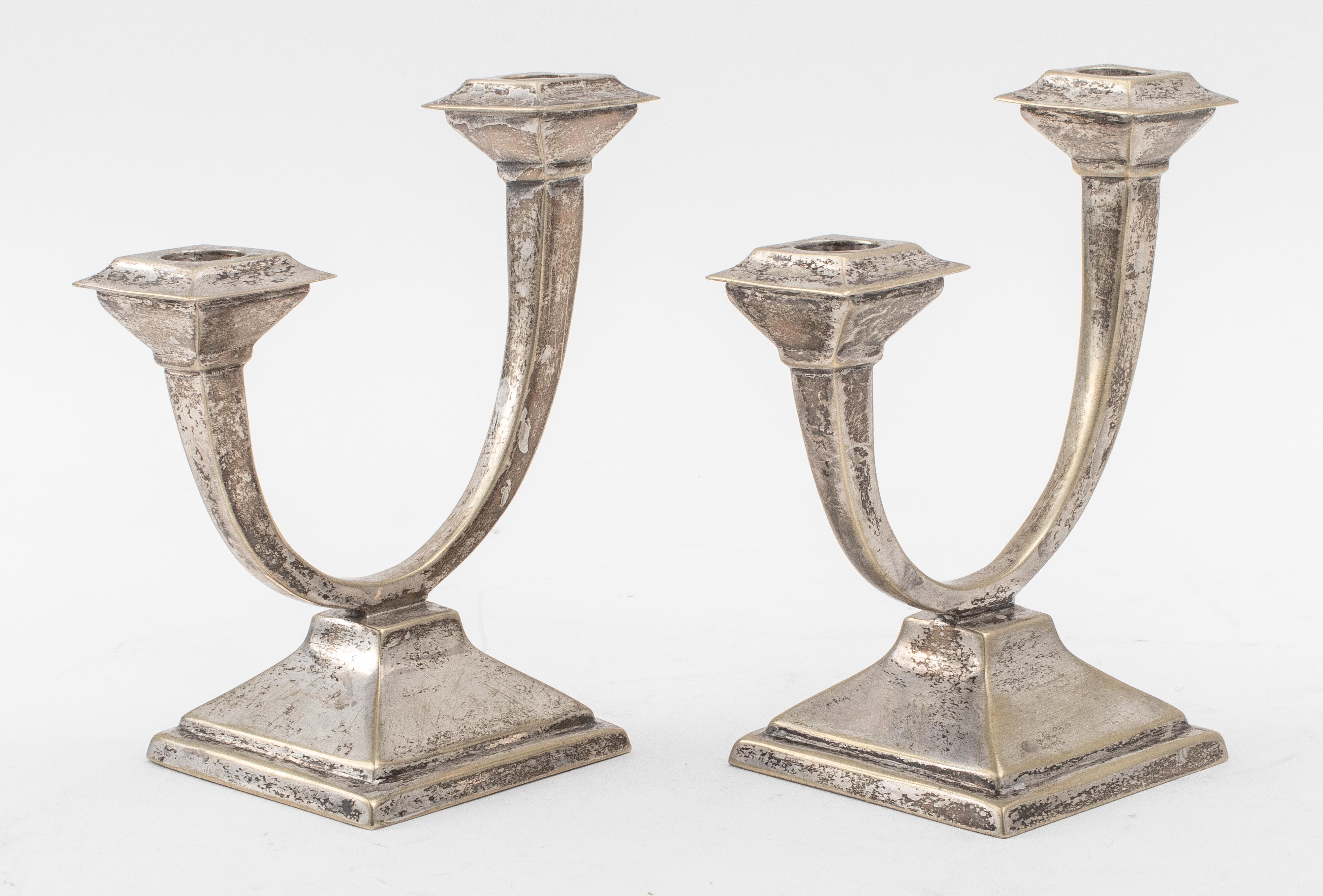 Pair of Silverplate 2 light candelabra with high low design on a square pyramidal base. 5.5