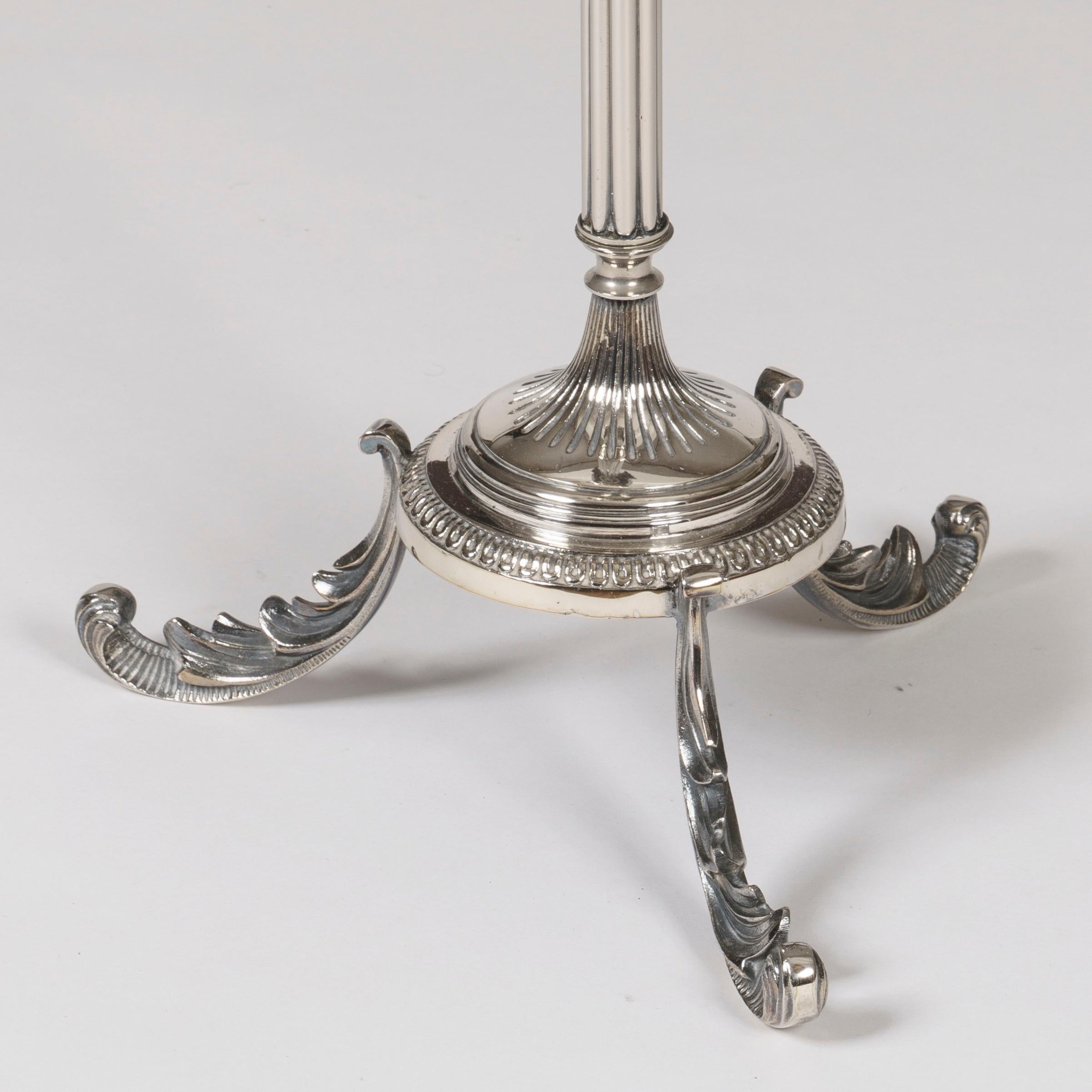 A silverplate and baccarat crystal
 Champagne bucket and stand

Rising from scrolling tripartite legs, the reeded columnar stand having a circular fluted base and a flaring apex of four stylized acanthus leaves housing a later associated Baccarat