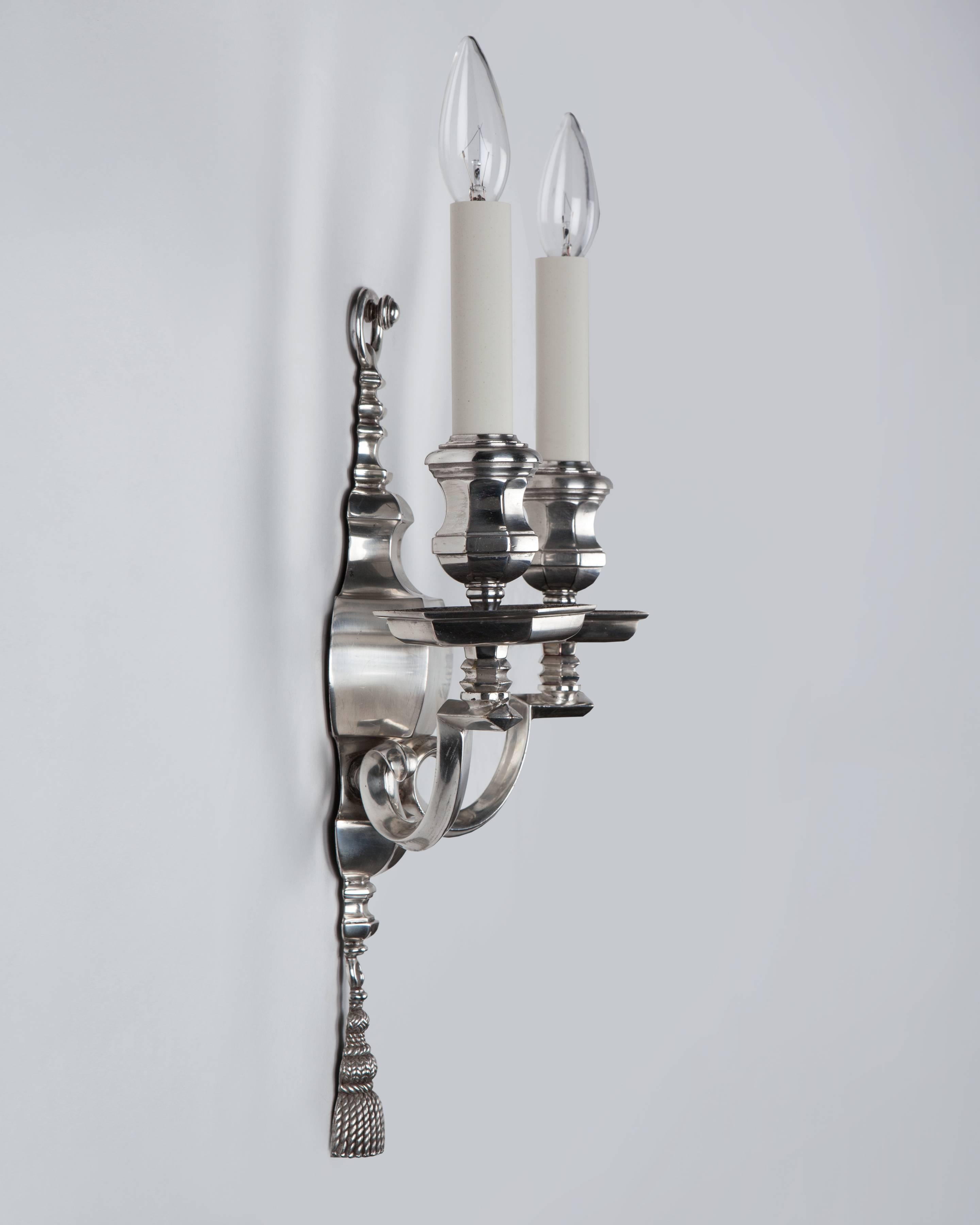 AIS3042
A pair of antique double-light sconces in their original silver plate over bronze finish with bold, faceted ware-form back plates and cups, and diamond section arms.

Dimensions:
Overall: 17-1/4