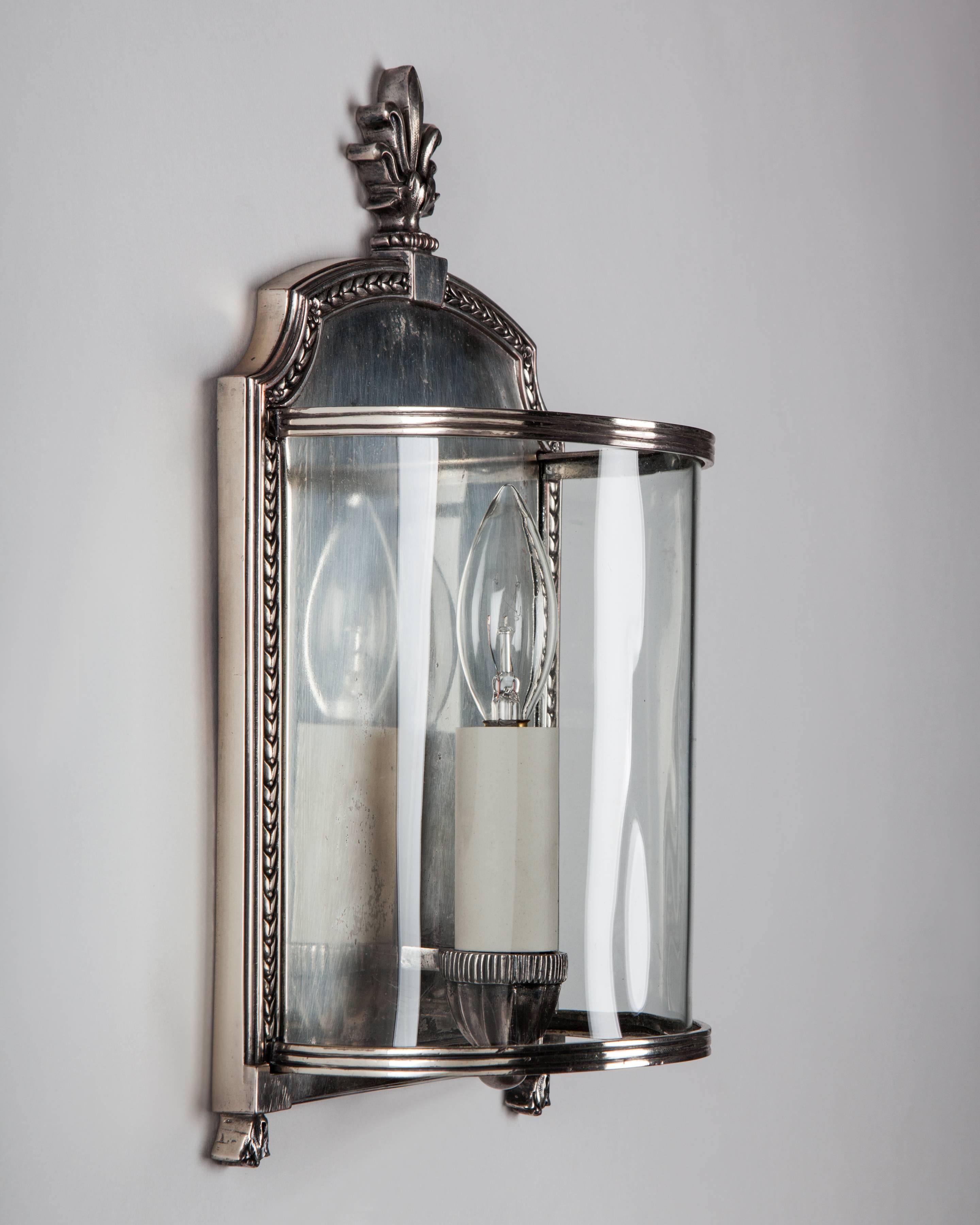 AIS3059
A pair of antique wall sconces with curved glass shades in their original aged silver plate. By the New York maker E. F. Caldwell Co. Due to the antique nature of this fixture, there may be some nicks or imperfections in the