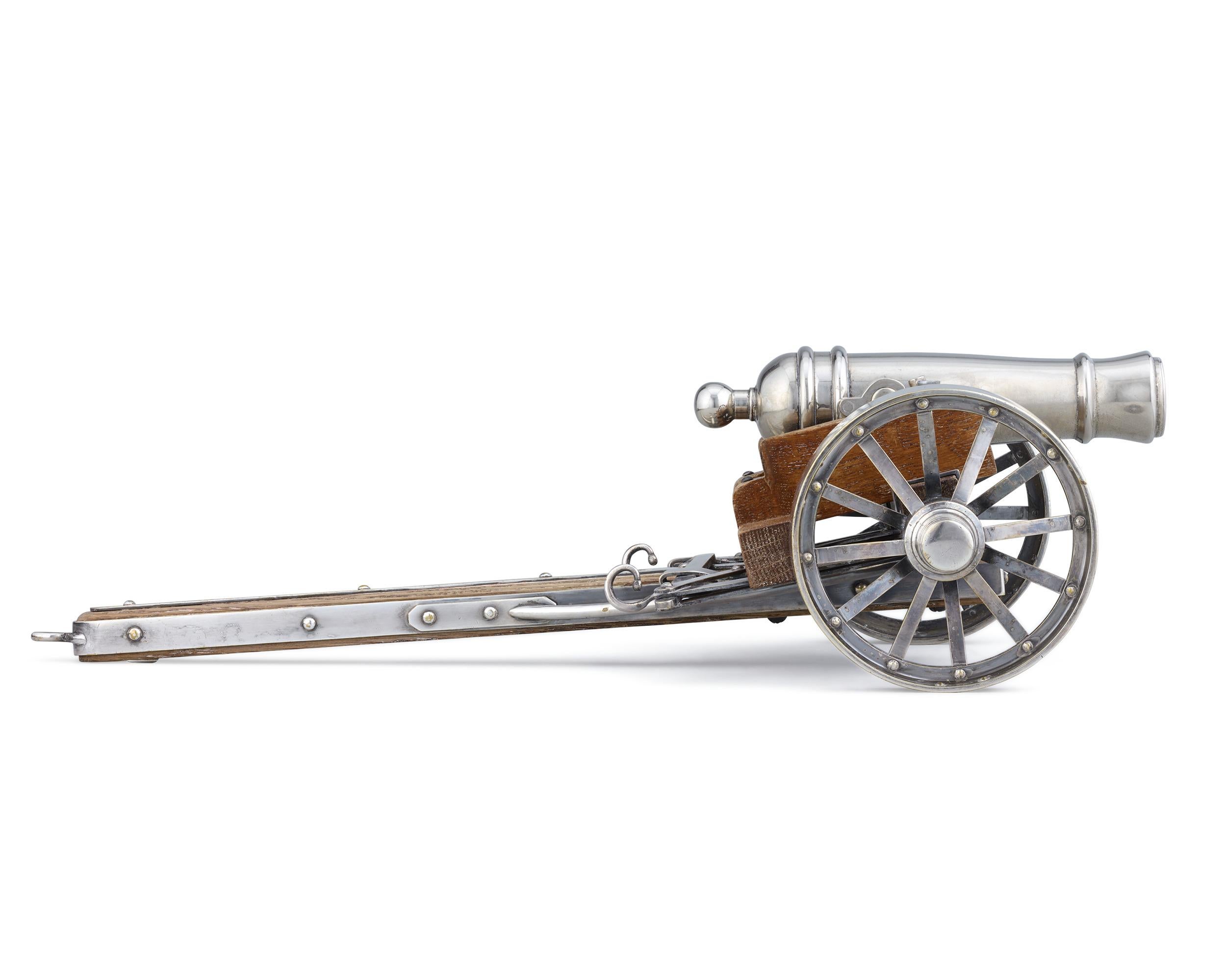 This exceptional objet d'art is modeled after a cannon from the siege of Mafeking, a 217-day conflict in South Africa during the Second Boer War. It is composed of silverplate over copper and showcases two wheels. Models such as these were highly